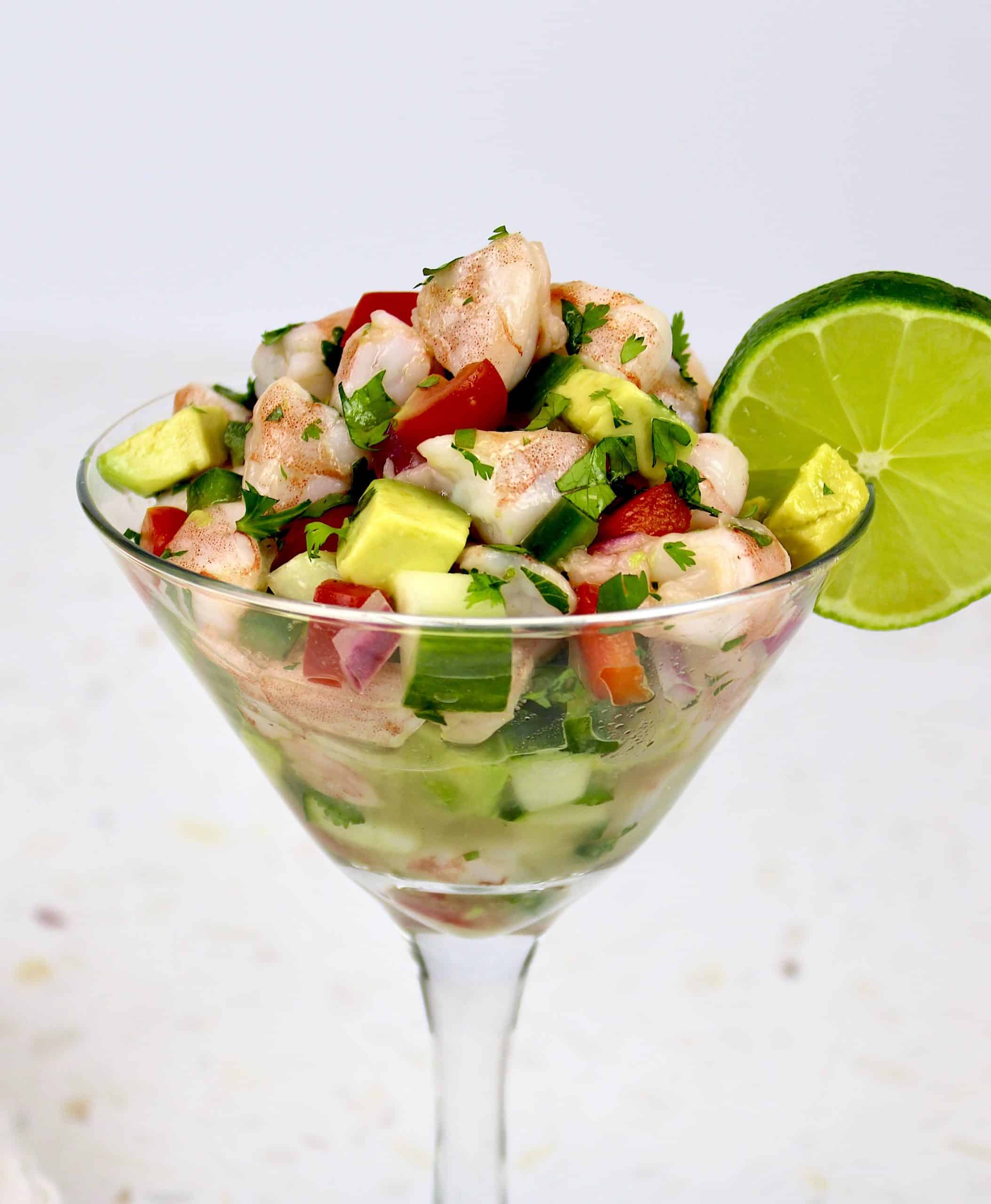 Shrimp Ceviche in cocktail glass with lime slice on glass