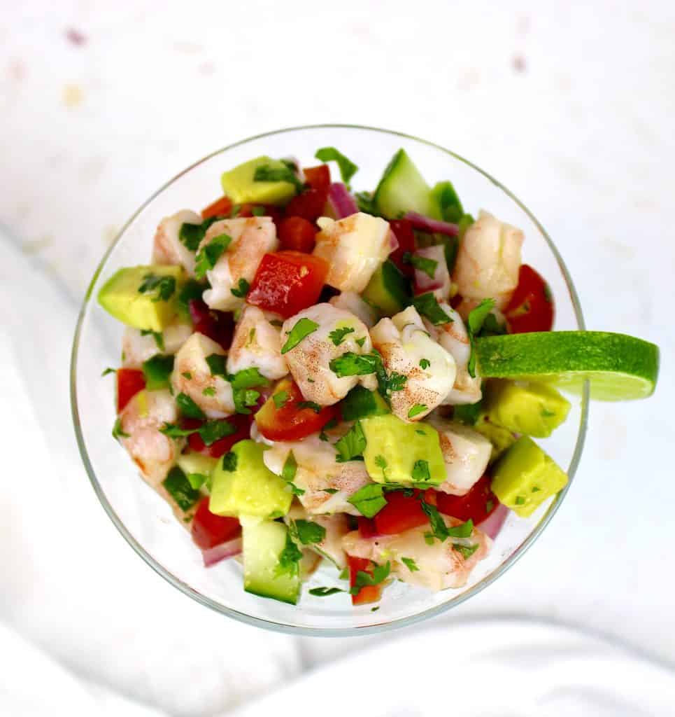 overhead view of Shrimp Ceviche in glass with lime slice on side of glass