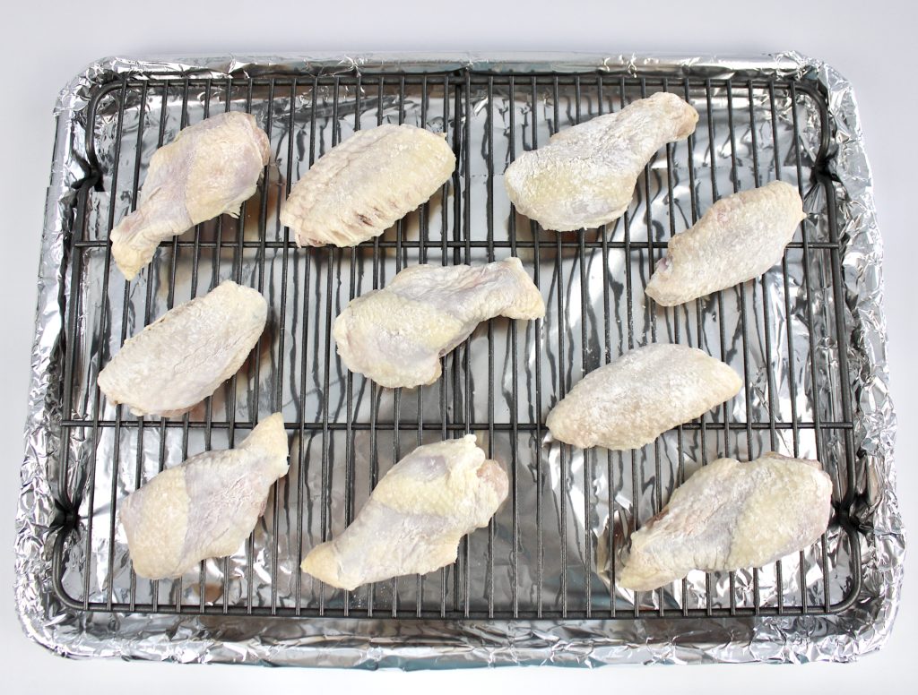 10 raw chicken wings on baking rack