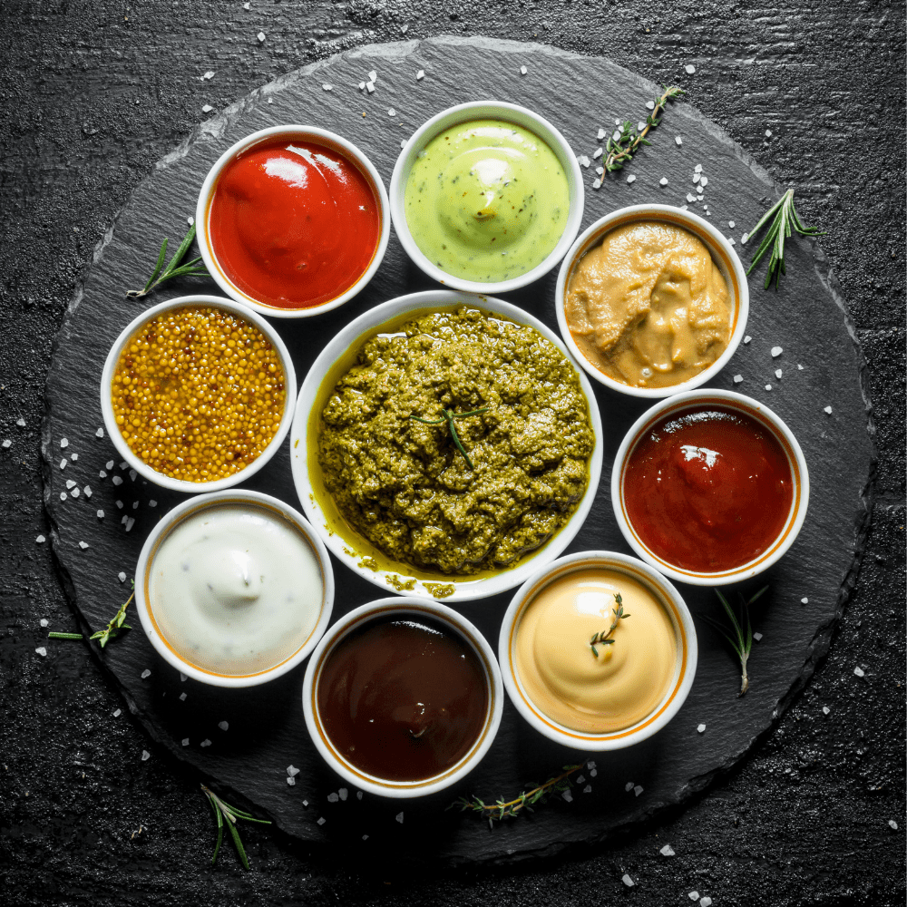 sauces in cups on slate background