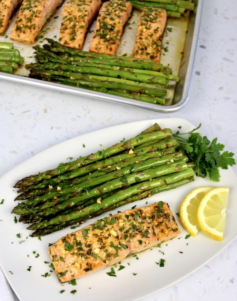 overhead view of Baked Salmon with Asparagus on plate with sheet pan in background