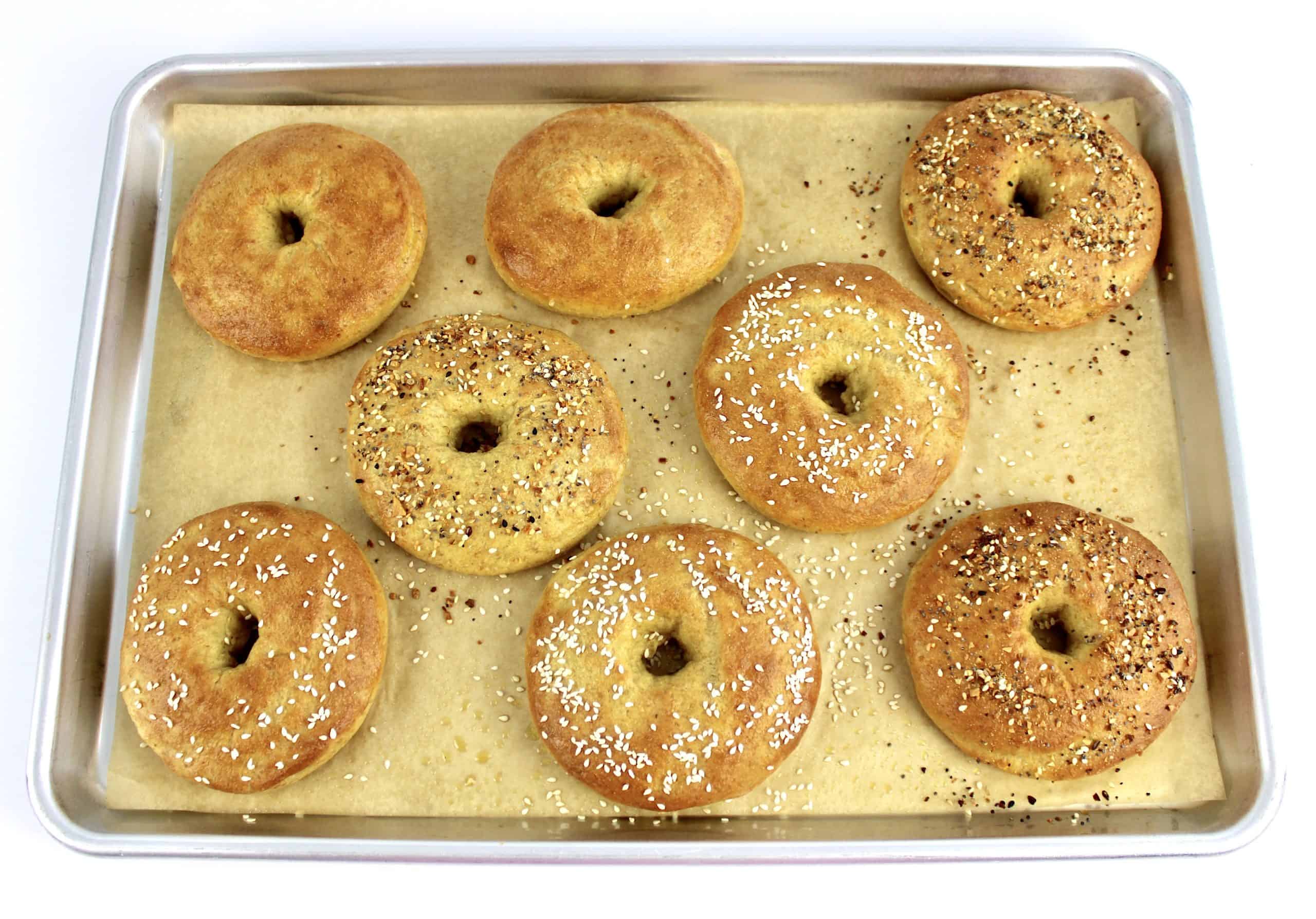 8 baked bagels on parchment lined baking sheet