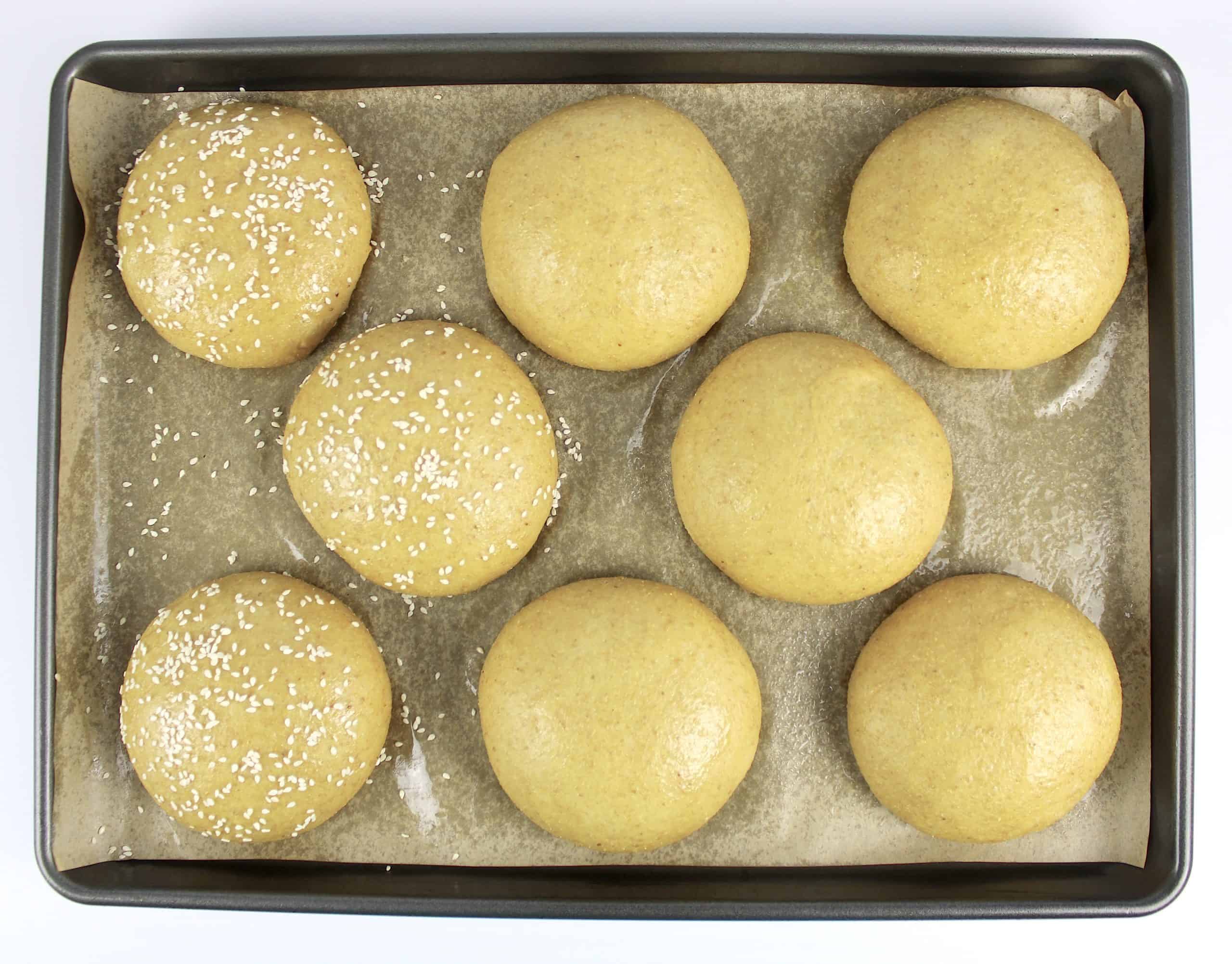 8 keto bun dough balls on parchment lined baking sheet