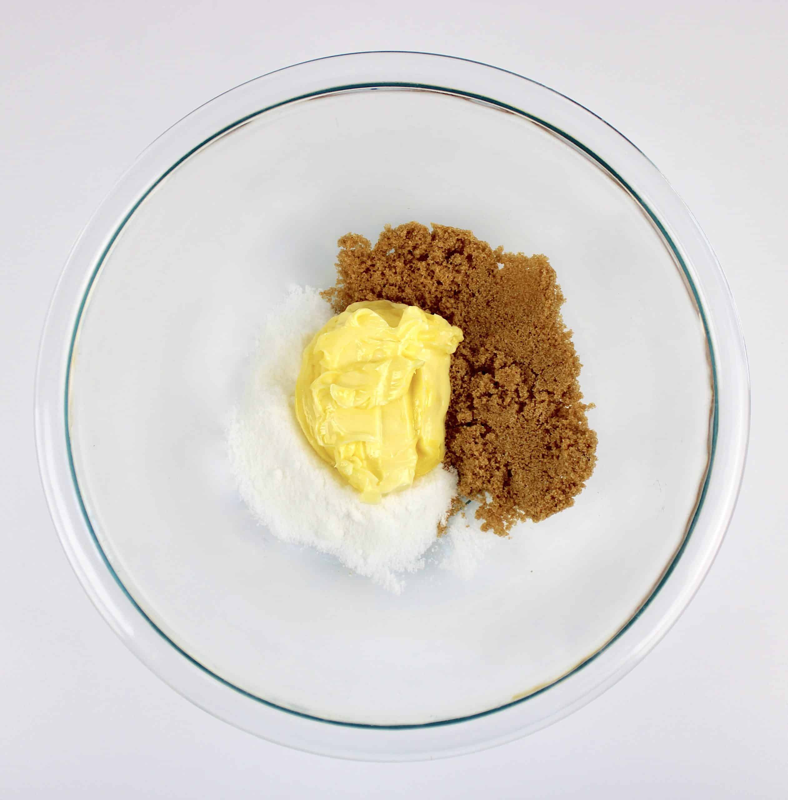 sugar and brown sugar with butter in glass bowl