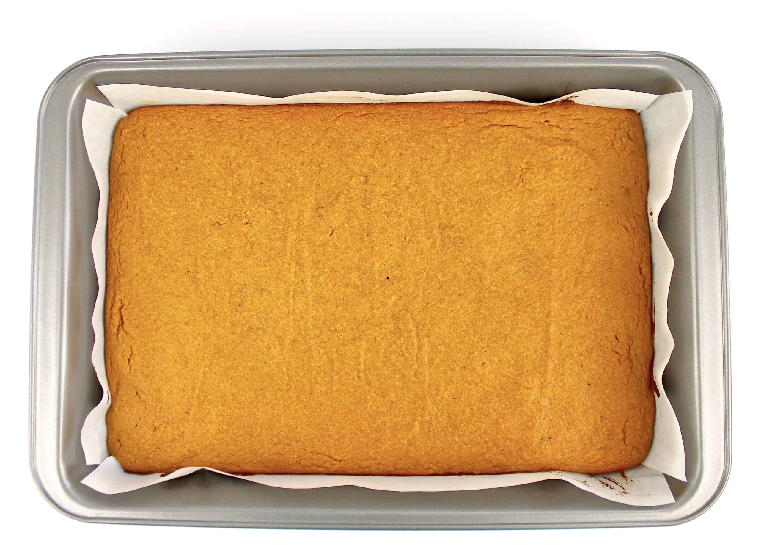 pumpkin bars batter in baking pan with parchment paper baked