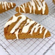 pumpkin scones with white icing on cooling rack