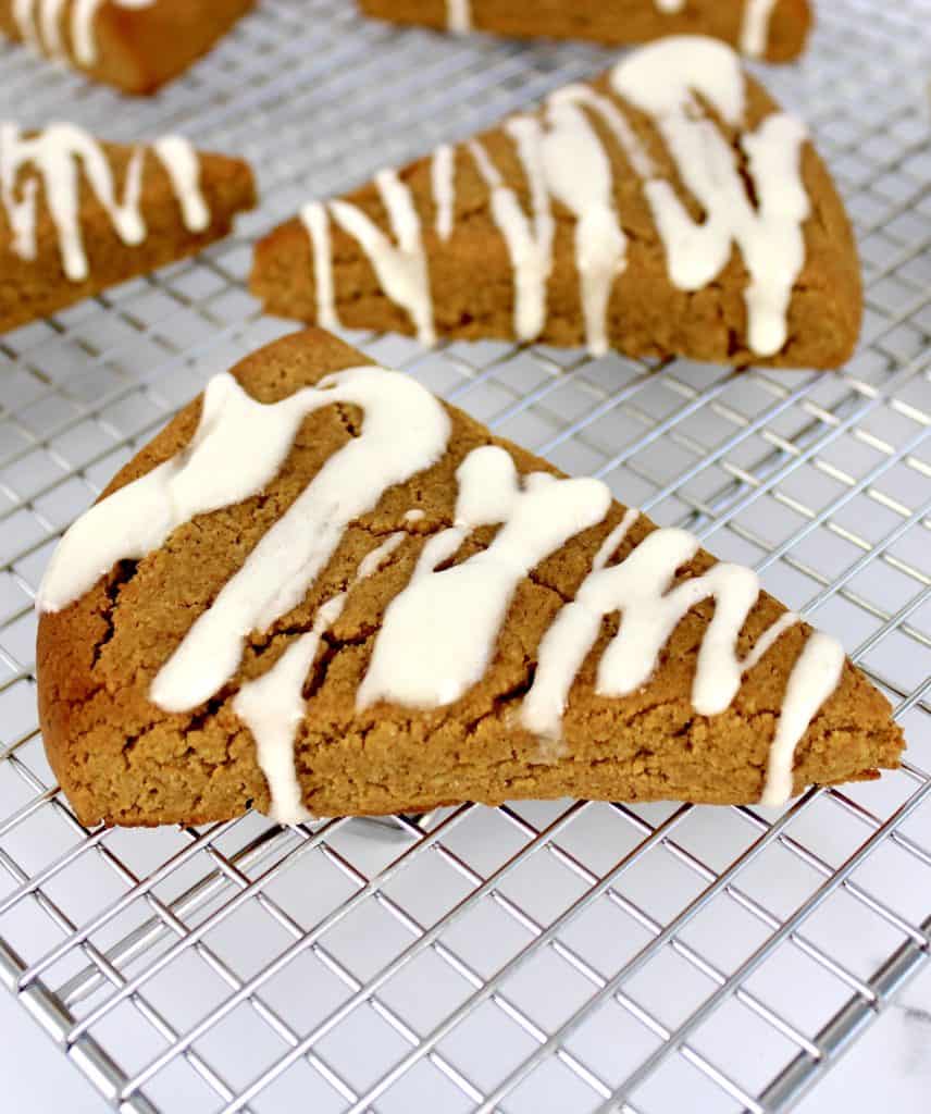 pumpkin scones with white icing on cooling rack