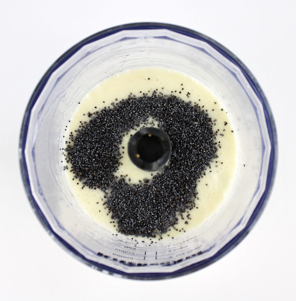 creamy dressing with poppy seeds on top