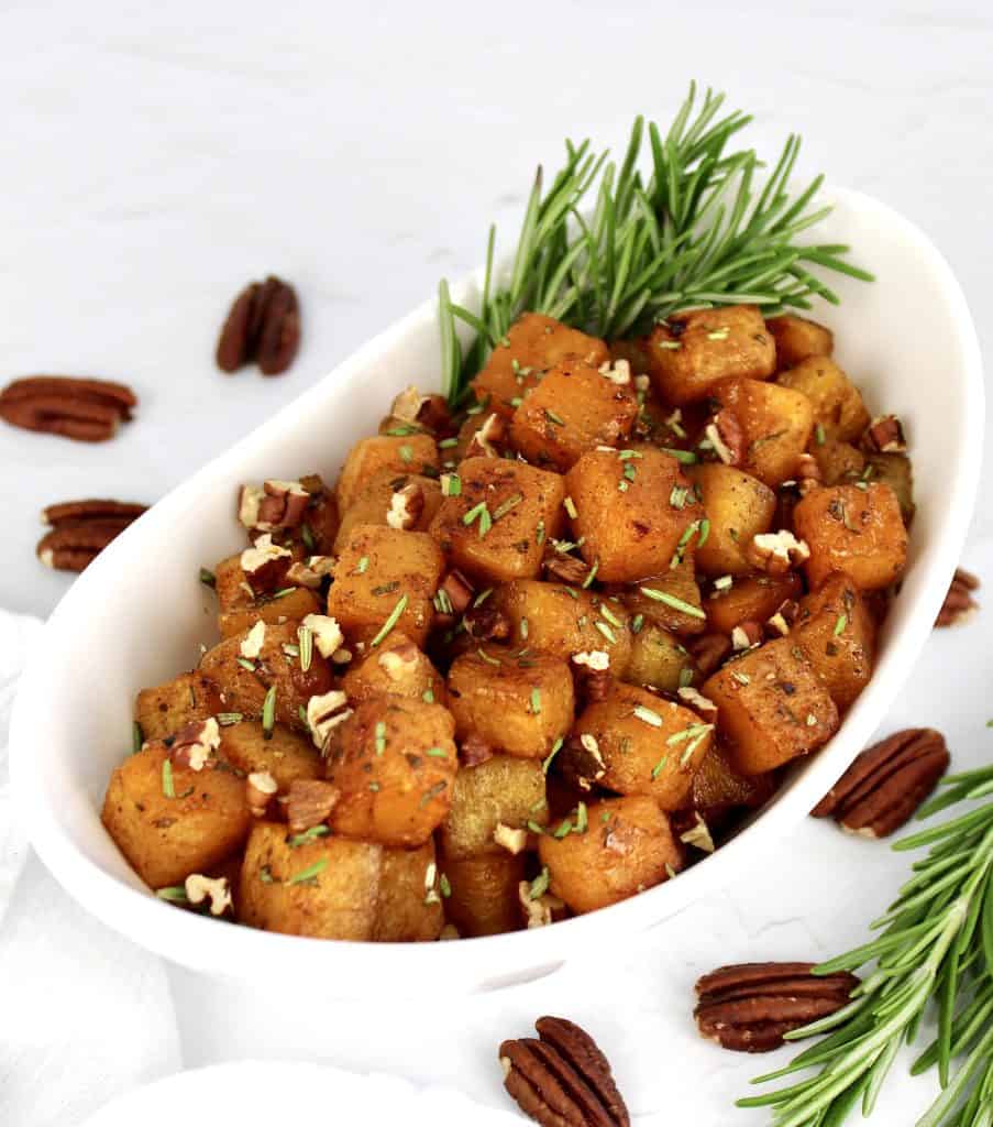 Maple Roasted Butternut Squash in white bowl with rosemary garnish