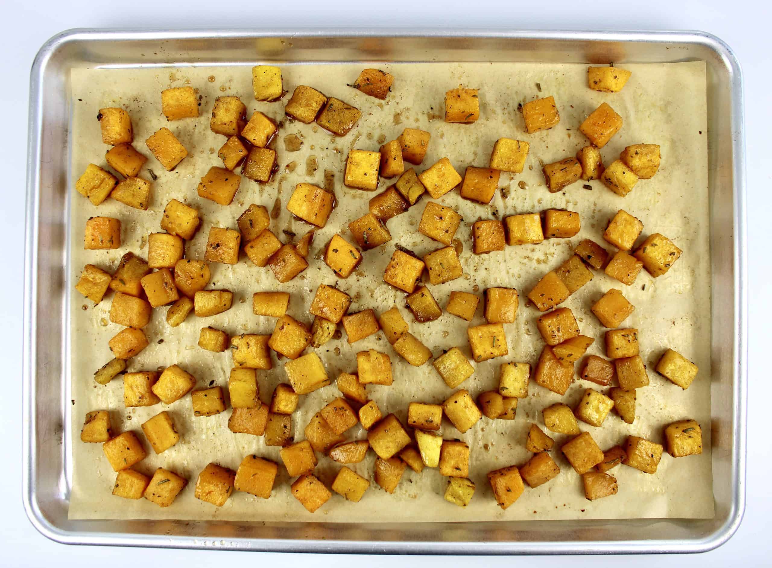 roasted butternut squash on parchment paper lined baking sheet