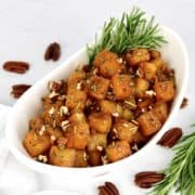 Maple Roasted Butternut Squash in white bowl with rosemary garnish