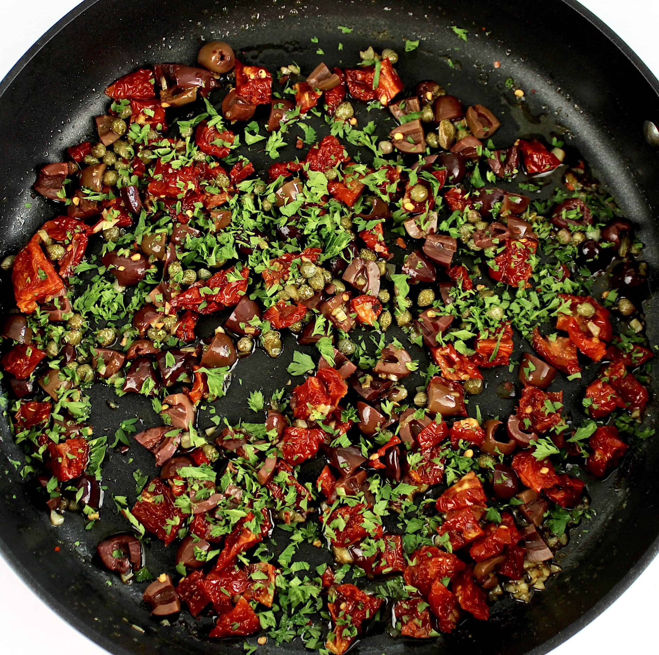 chopped olives sun-dried tomatoes and capers in skillet