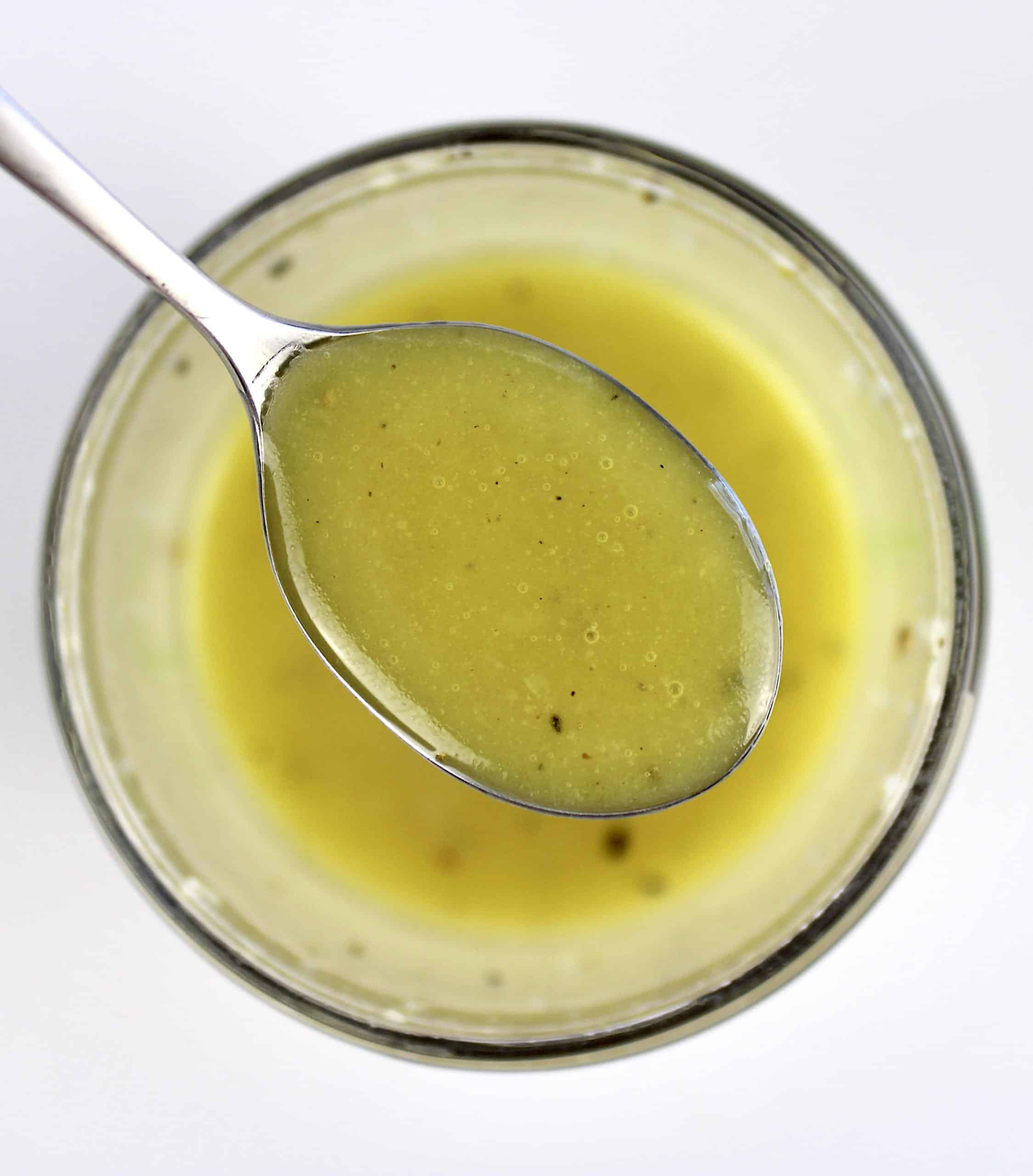 salad dressing being spooned out of container