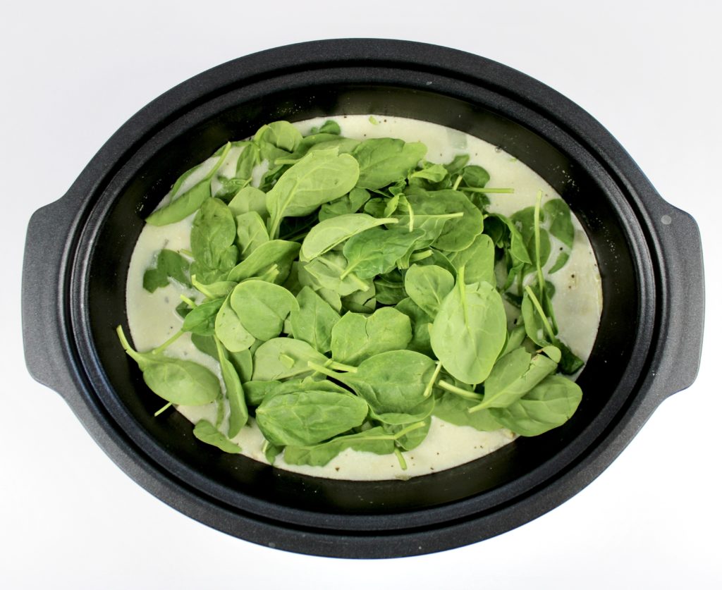raw spinach in soup in slow cooker