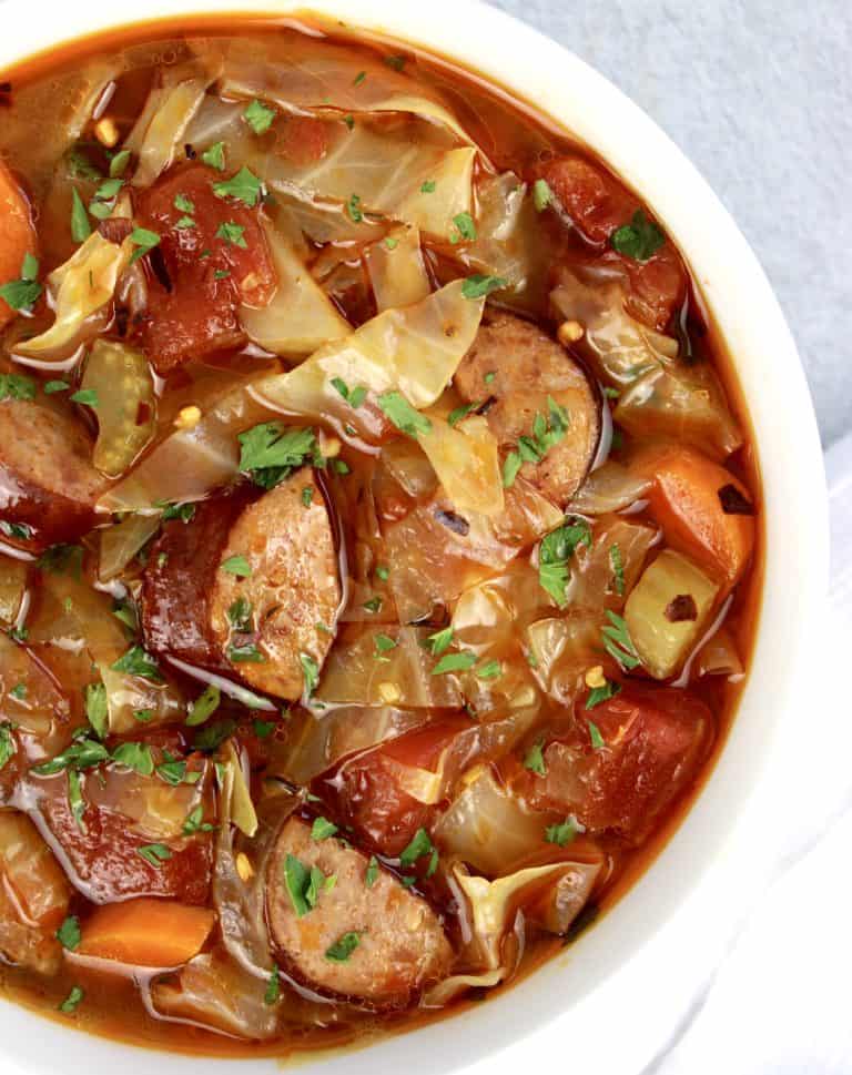 overhead view of Cabbage Soup with Sausage in white bowl