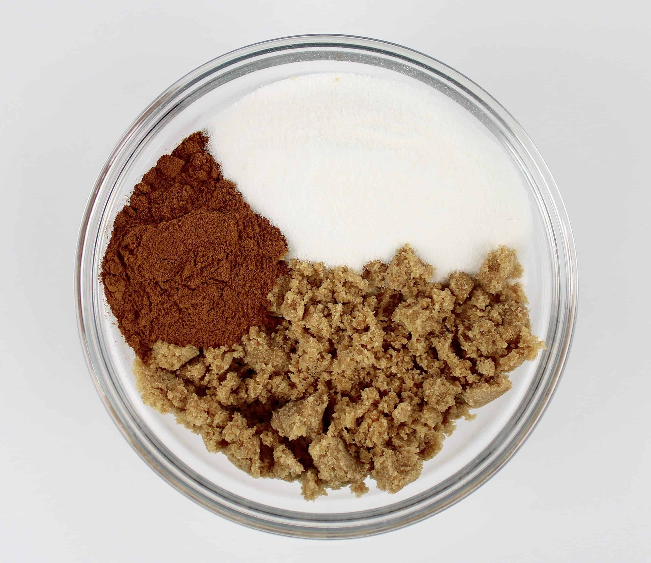 brown sugar sugar and cinnamon unmixed in glass bowl