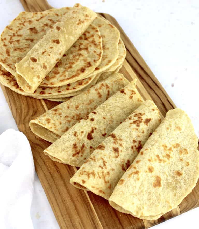 keto tortillas on wooden cutting board