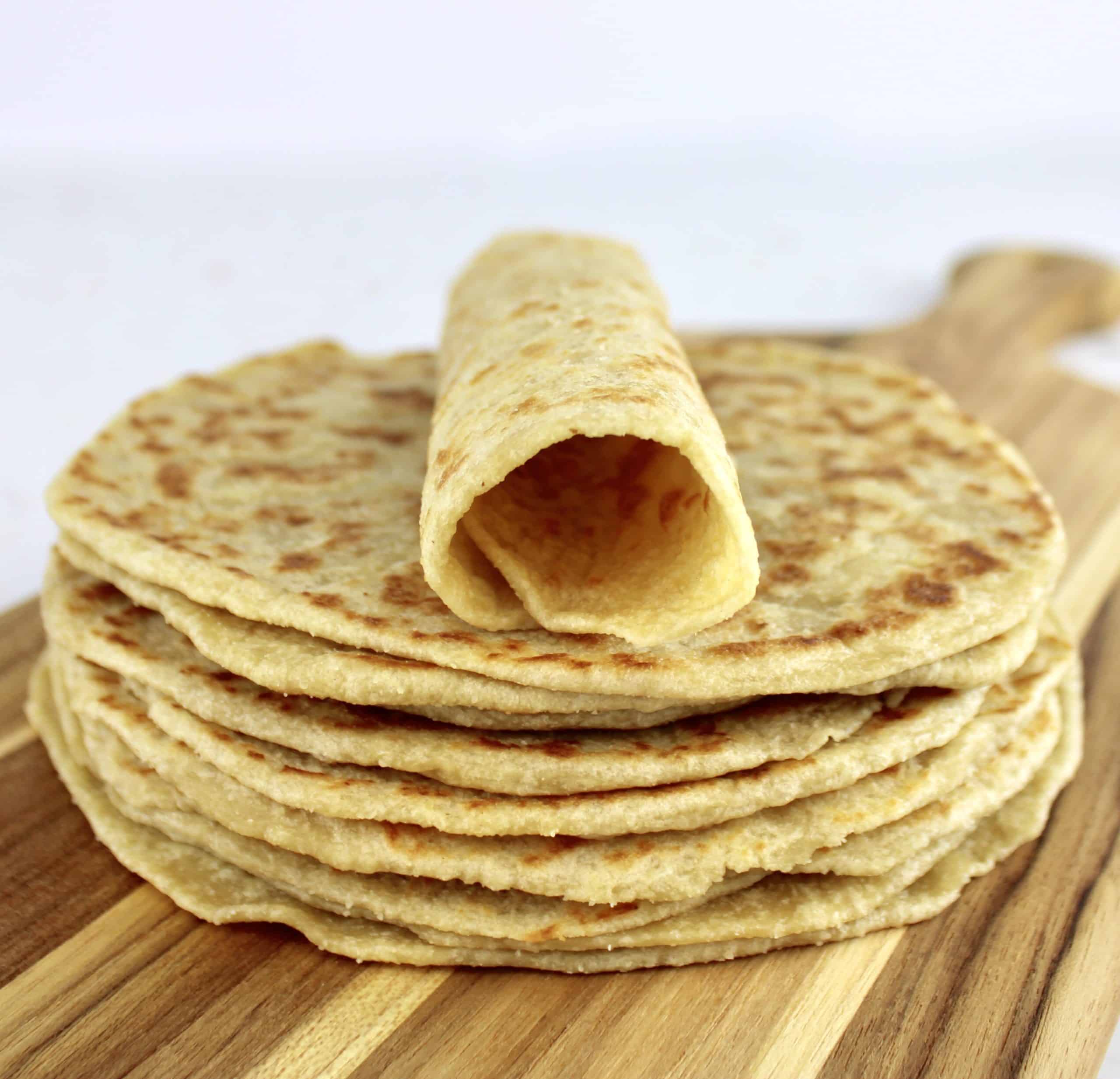stack of keto tortillas with one rolled up on top