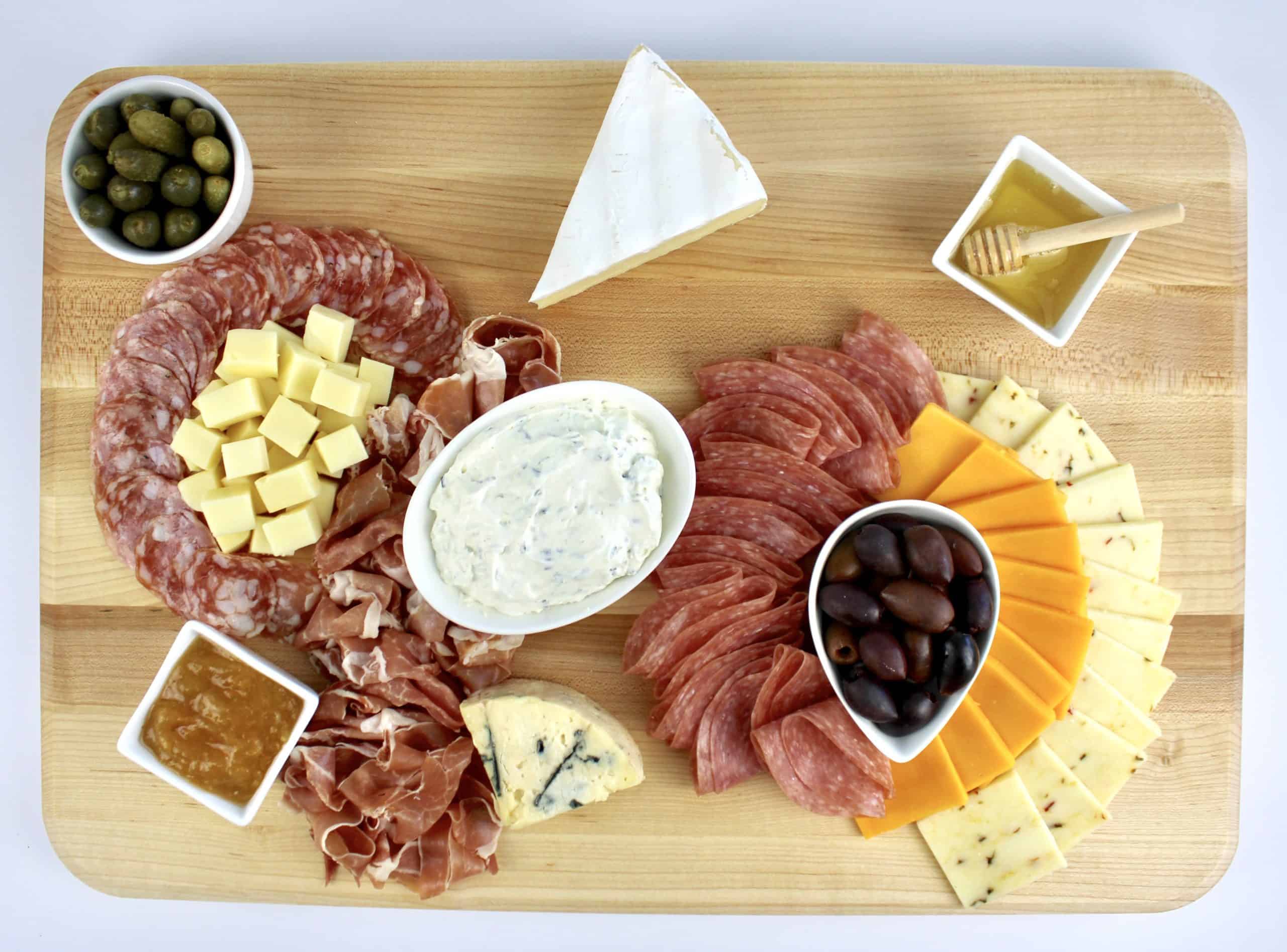 cheese board with meats and cheeses