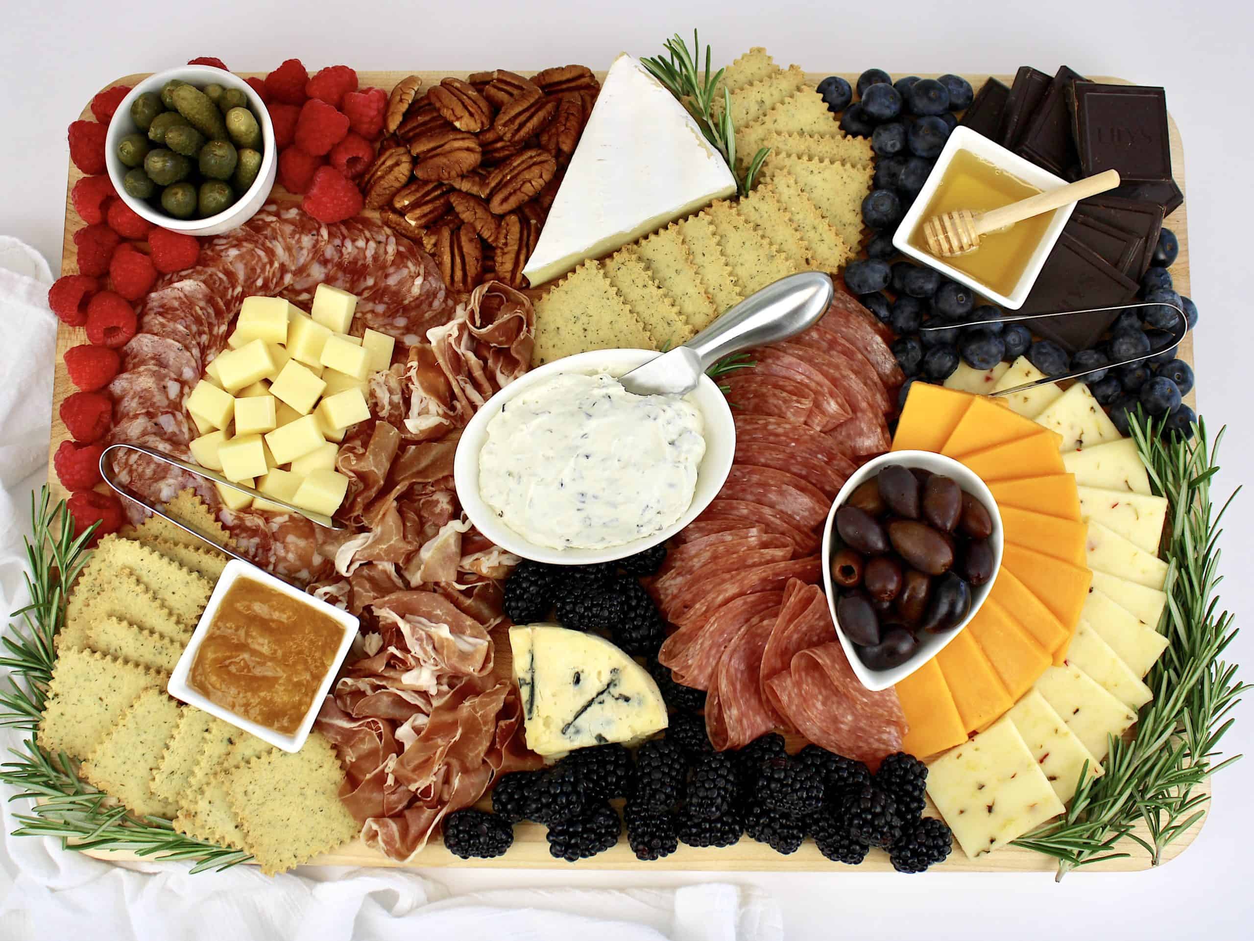 charcuterie board with meats cheeses berries