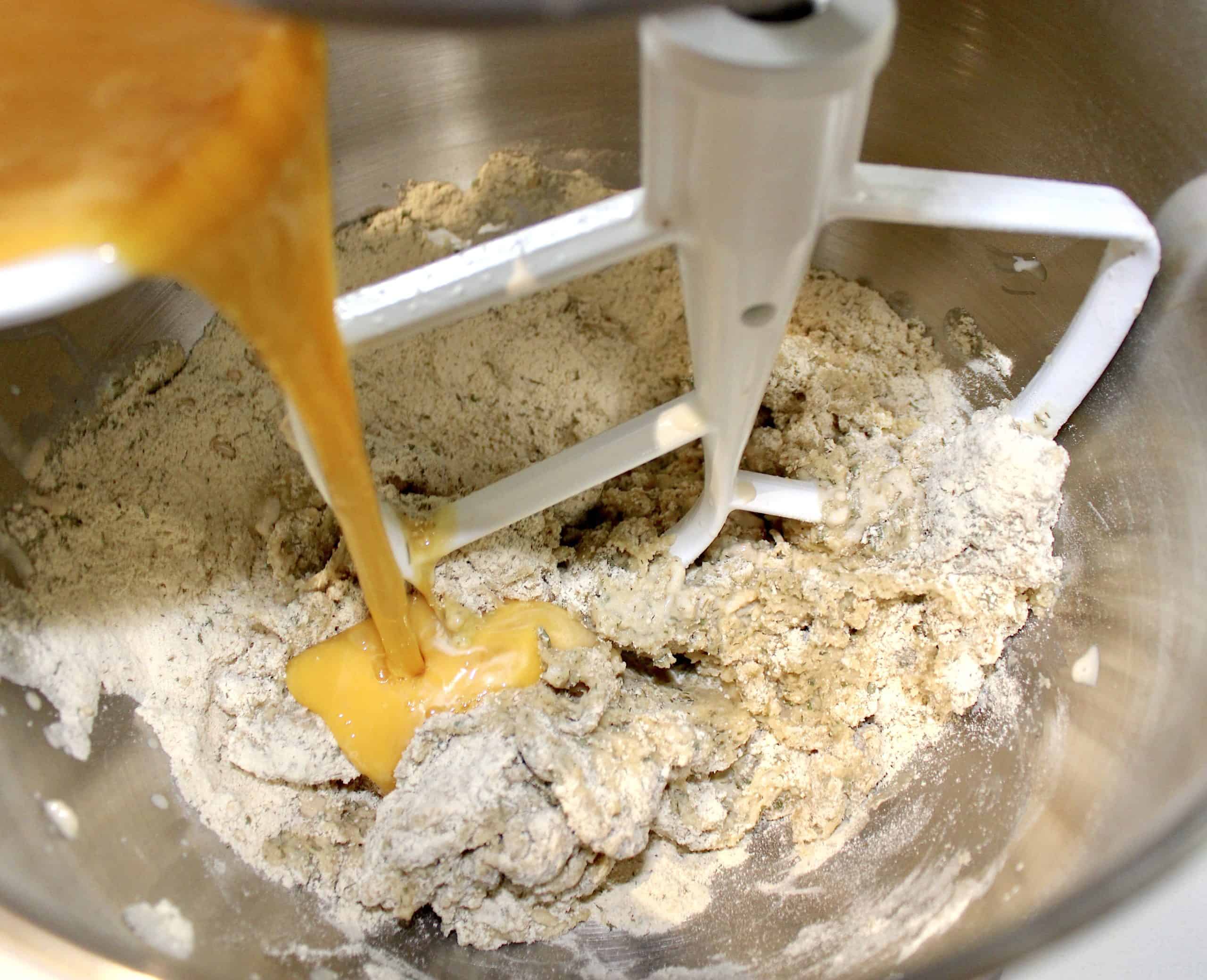 beaten eggs being poured into dough mixture