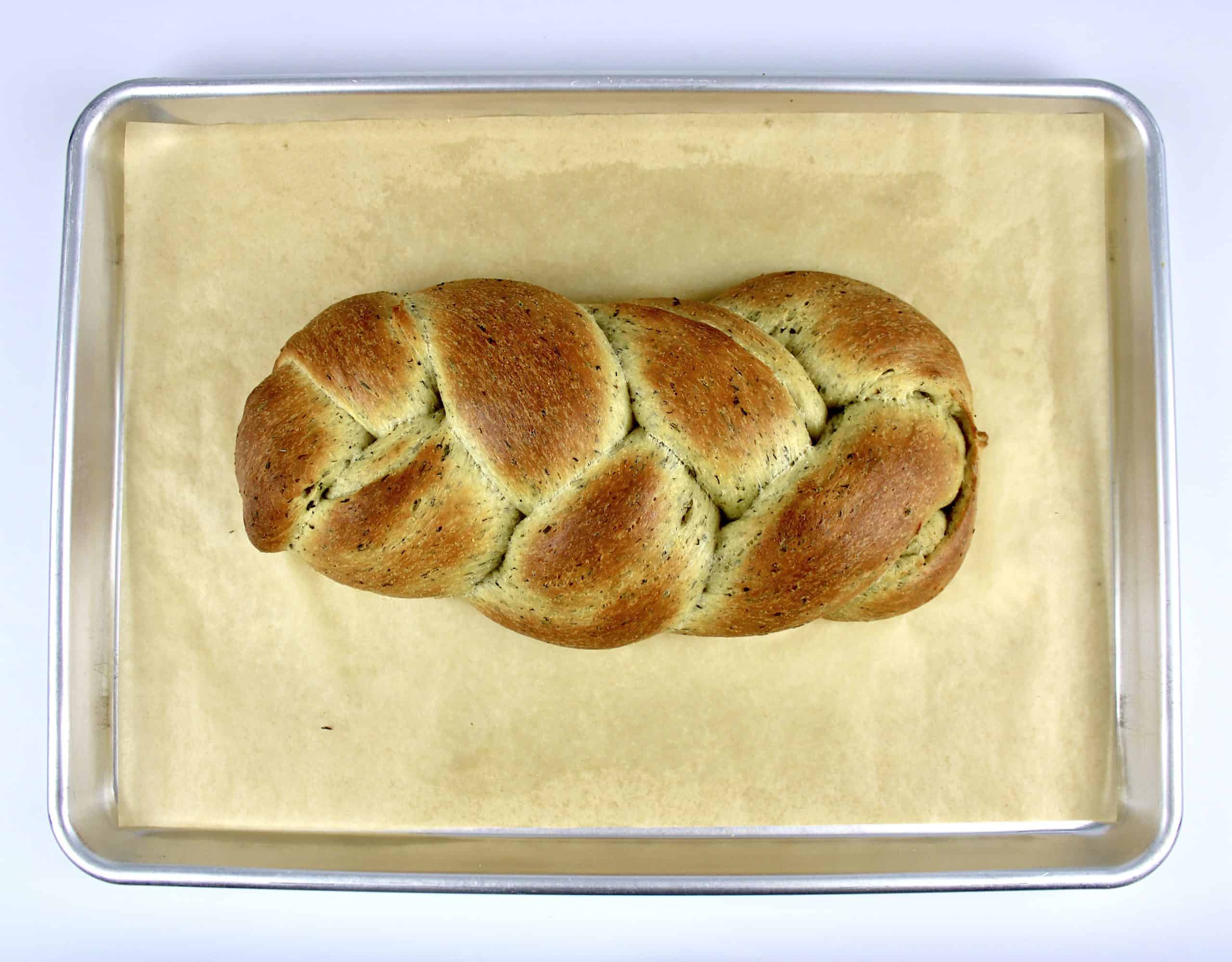 Keto Braided Herb Bread baked on baking sheet with parchment paper