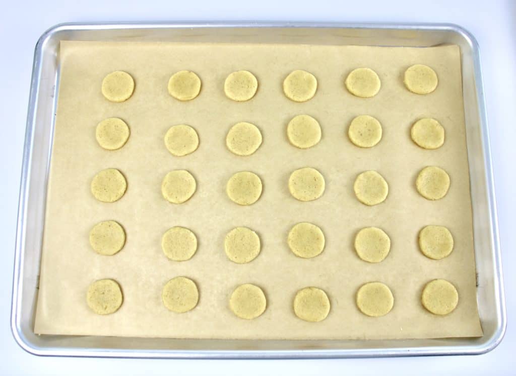 30 unbaked cookies on parchment lined baking sheet