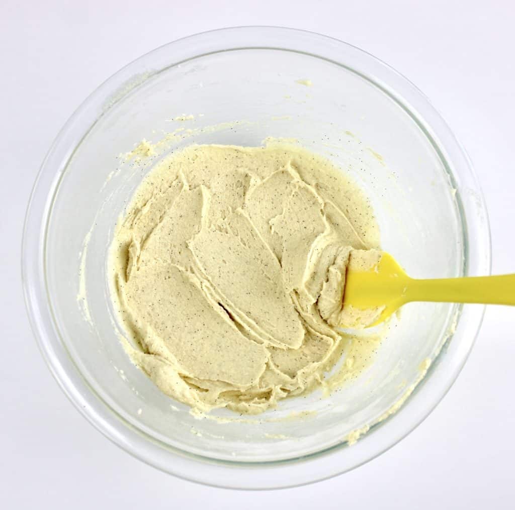 butter mixture in glass bowl with yellow spatula
