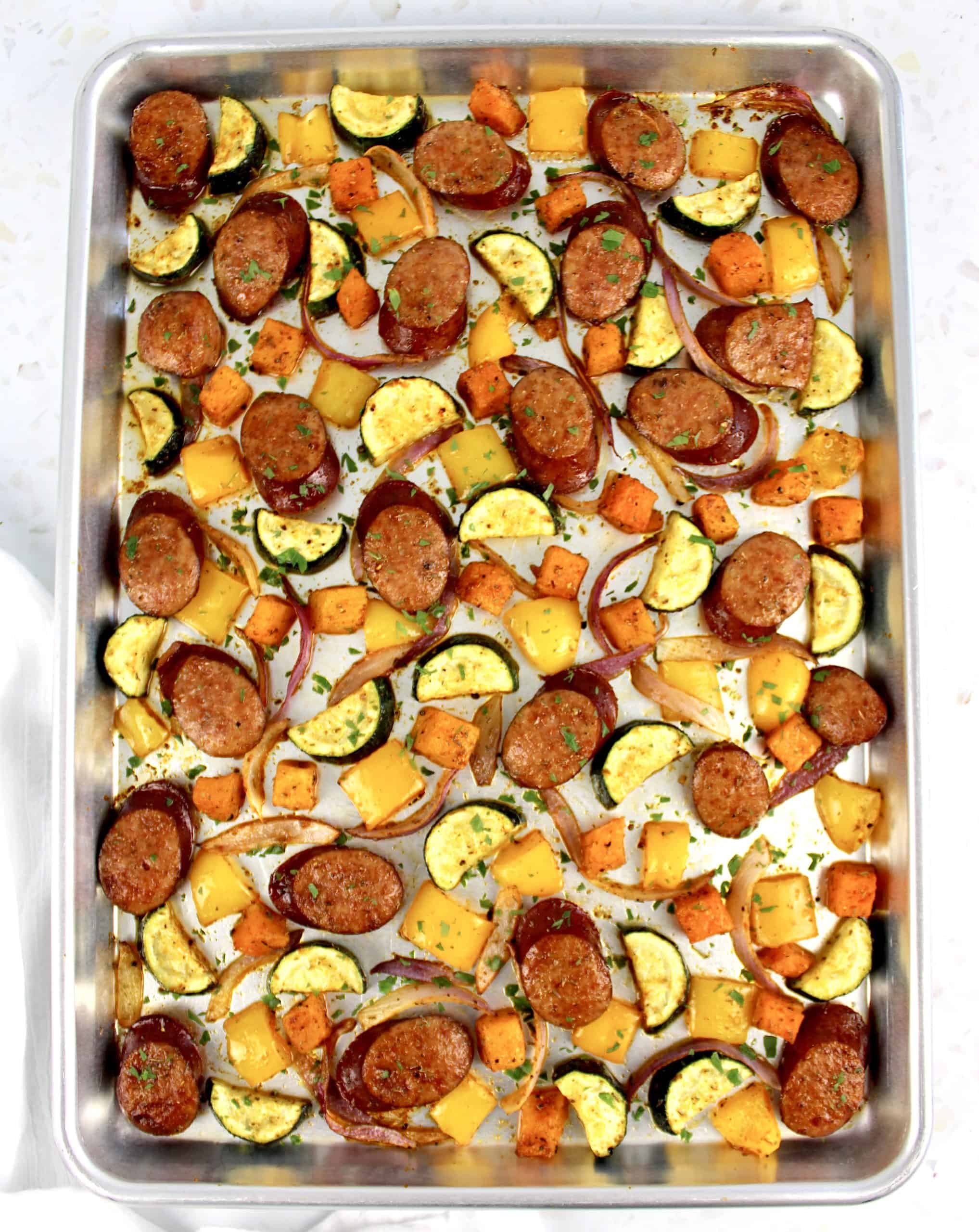 Sheet Pan Sausage and Veggies on baking sheet with chopped parsley