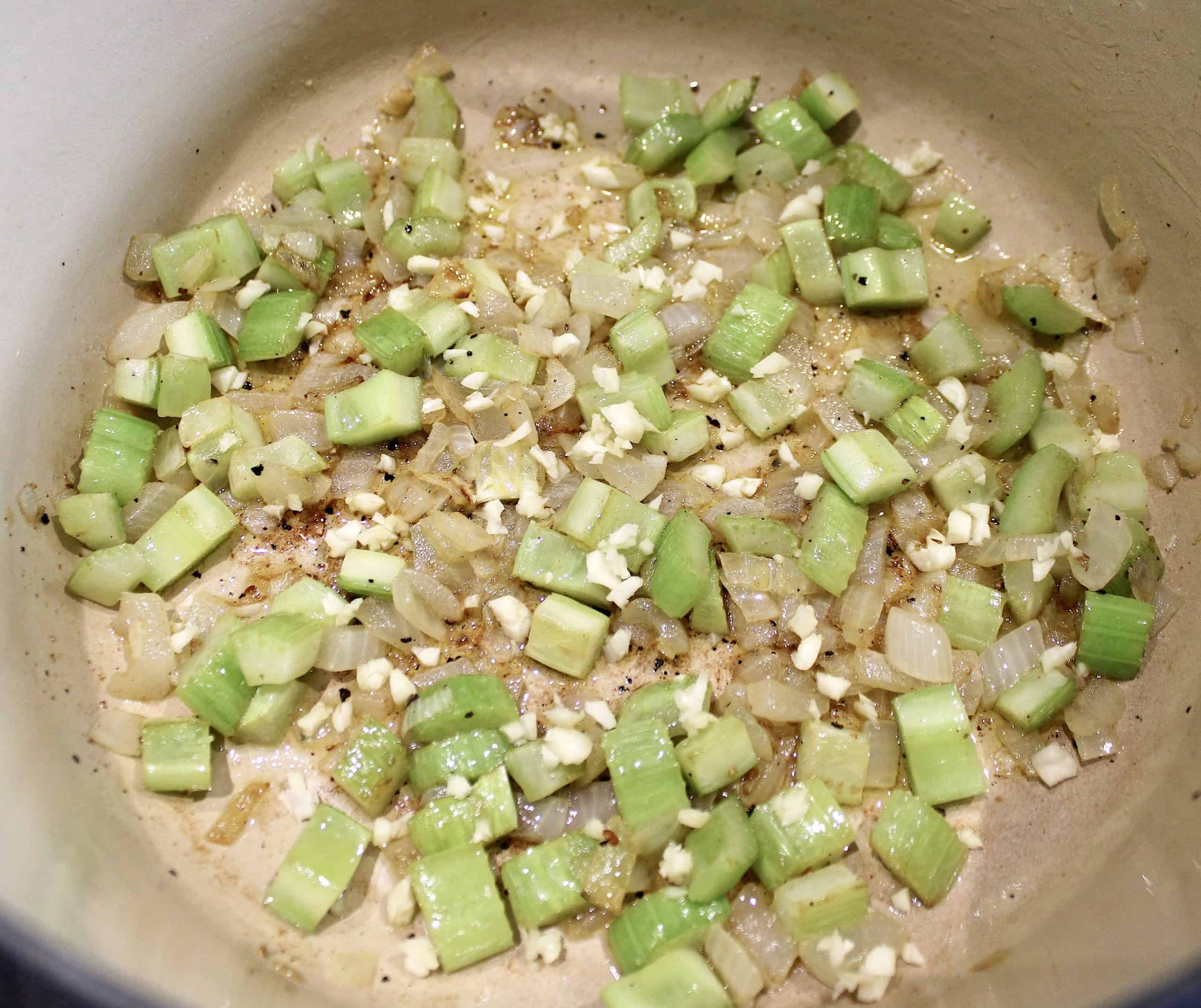 chopped celery and onion sautéing in pot