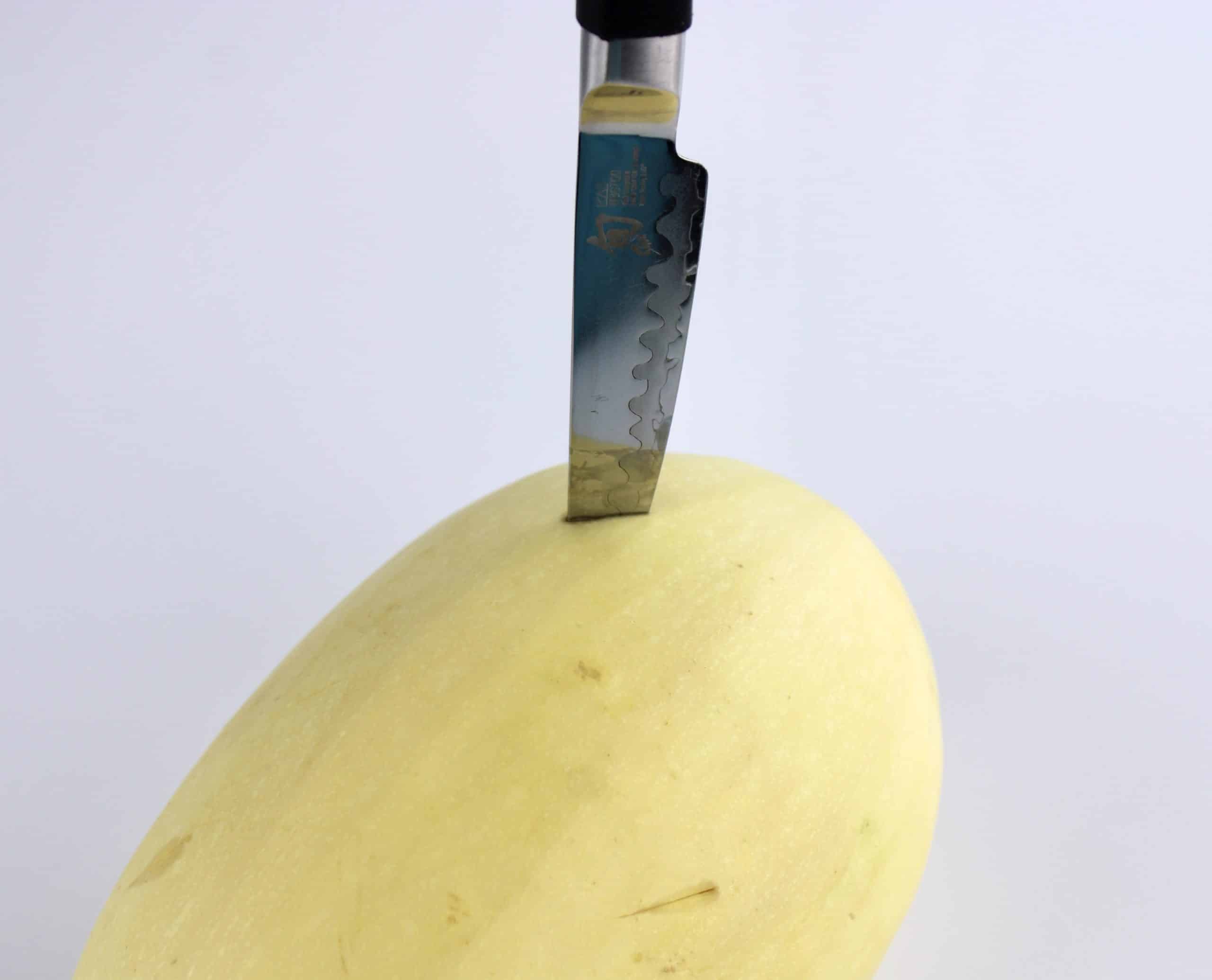 knife poking through a spaghetti squash