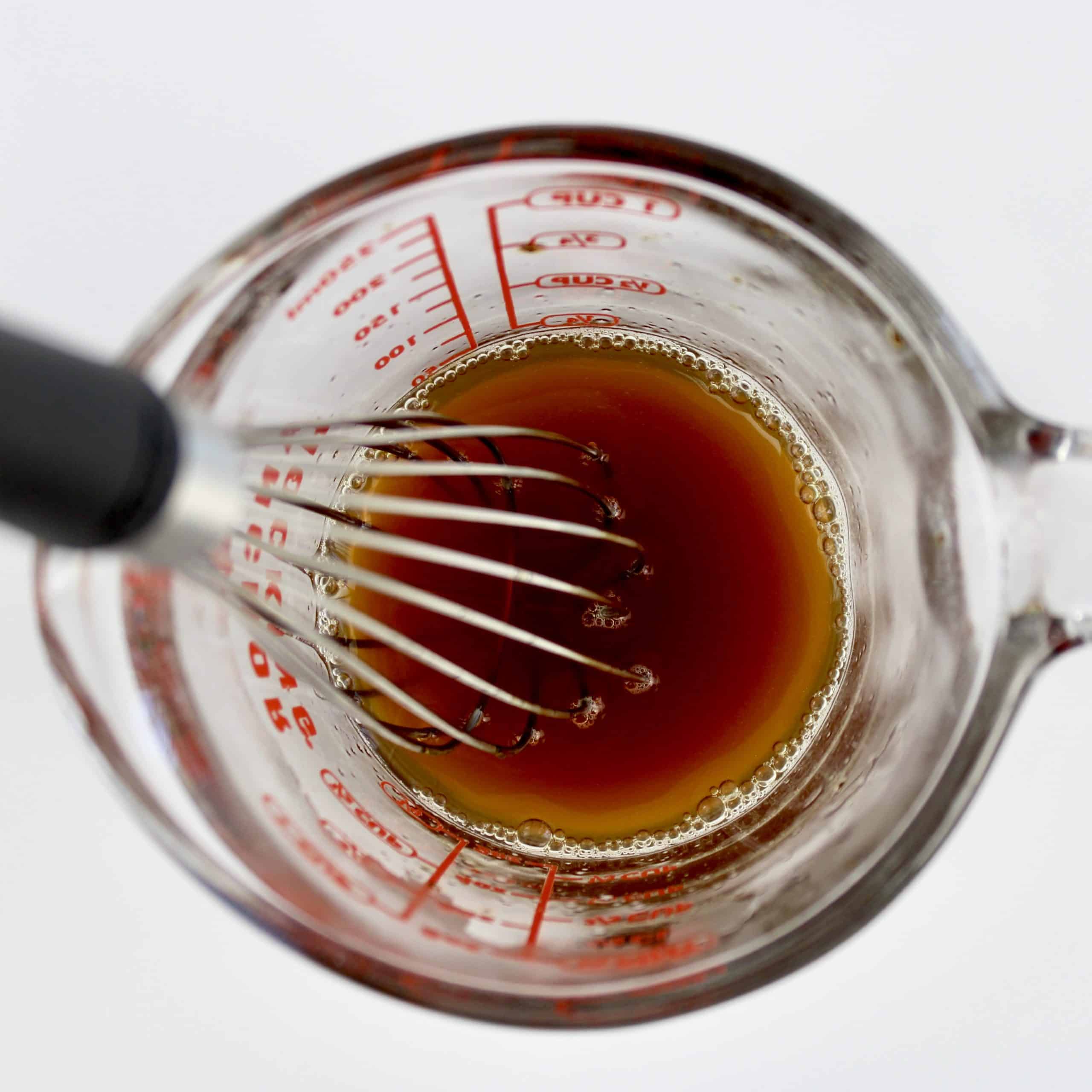 coffee in measuring cup with whisk