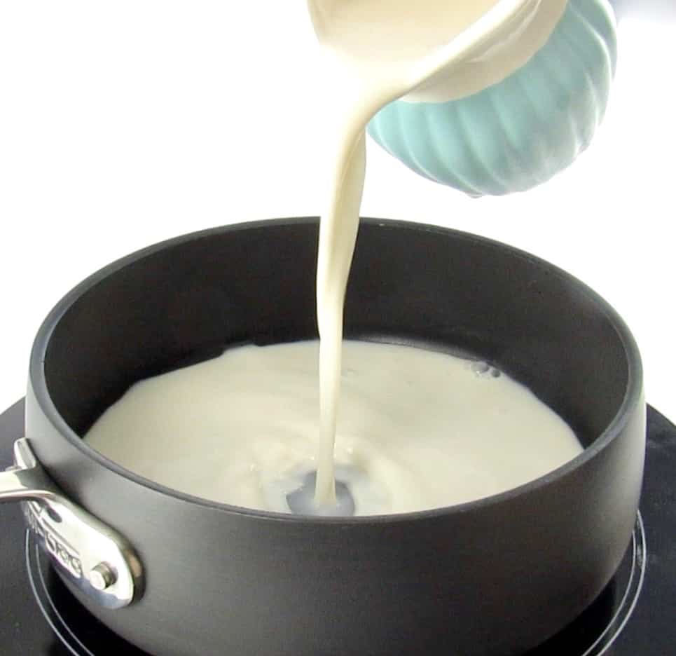 almond milk being poured into sauce pan