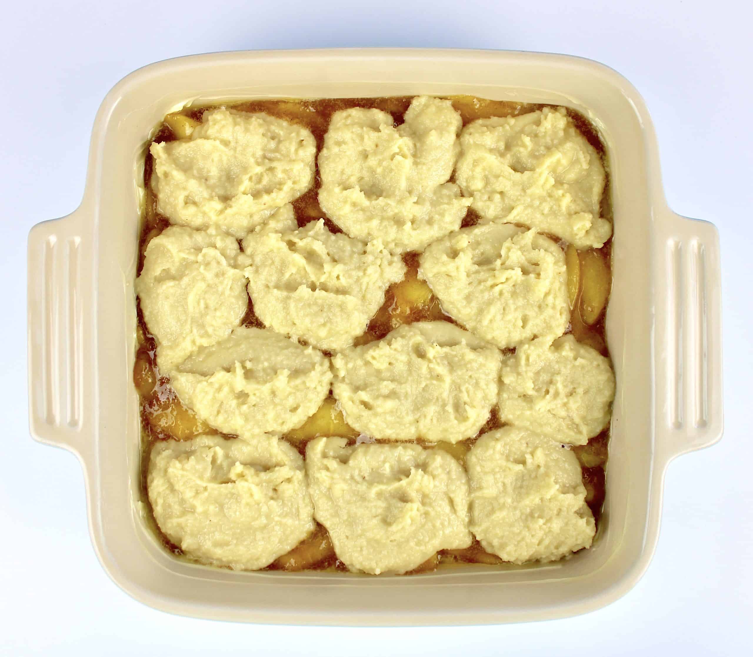 peach cobbler in baking dish unbaked