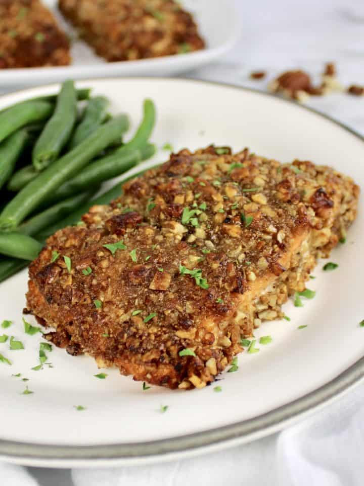 Pecan Crusted Salmon in white plate with green beans