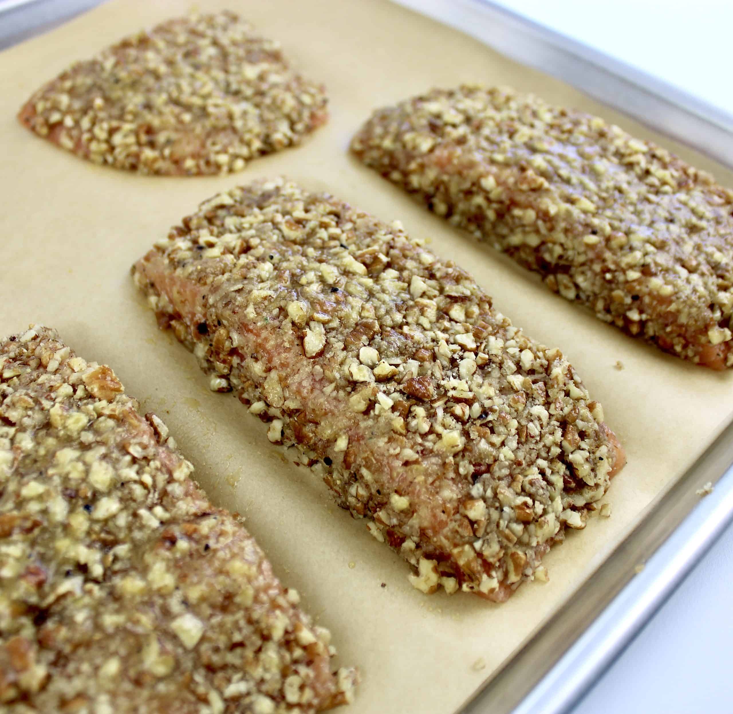 Pecan Crusted Salmon unbaked on parchment lined baking sheet