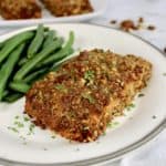 Pecan Crusted Salmon on white plate with green beans