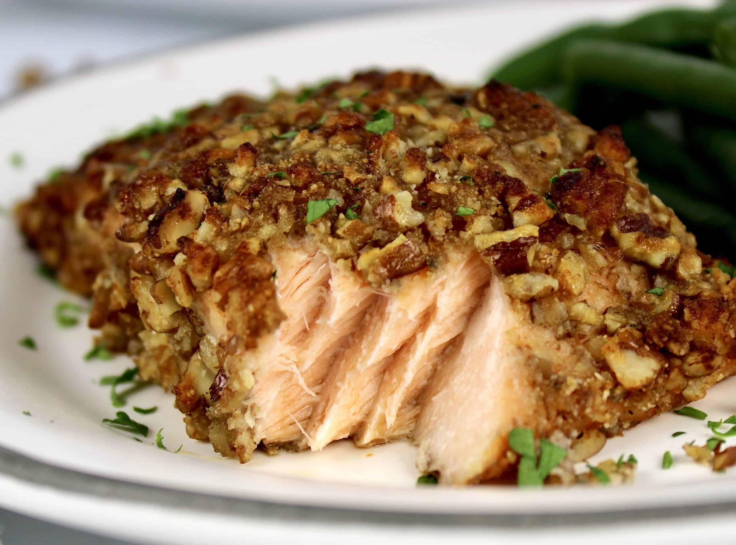 Pecan Crusted Salmon on white plate with bite taken out