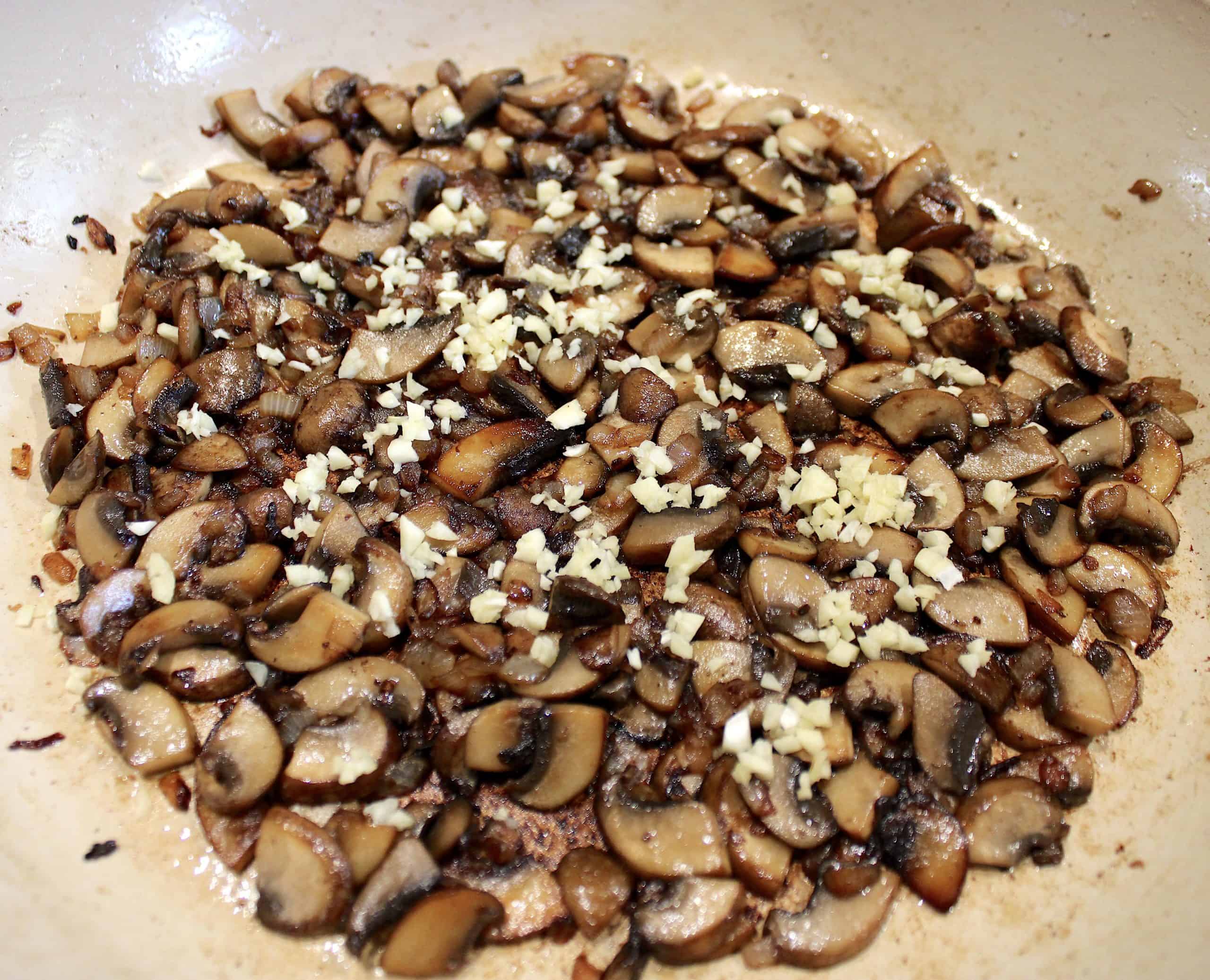 mushrooms onion and garlic sautéed in pan