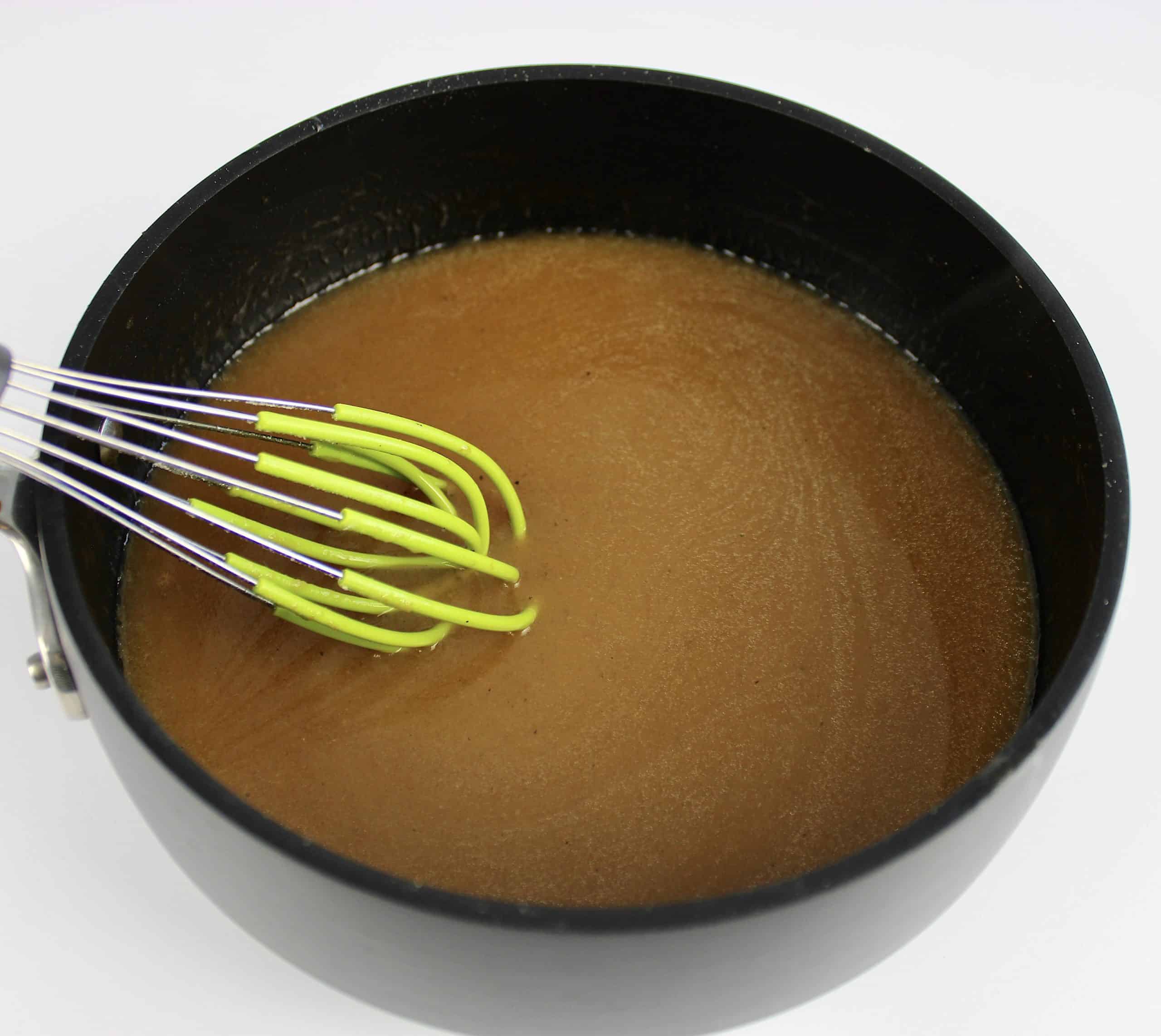 gravy in saucepan with whisk