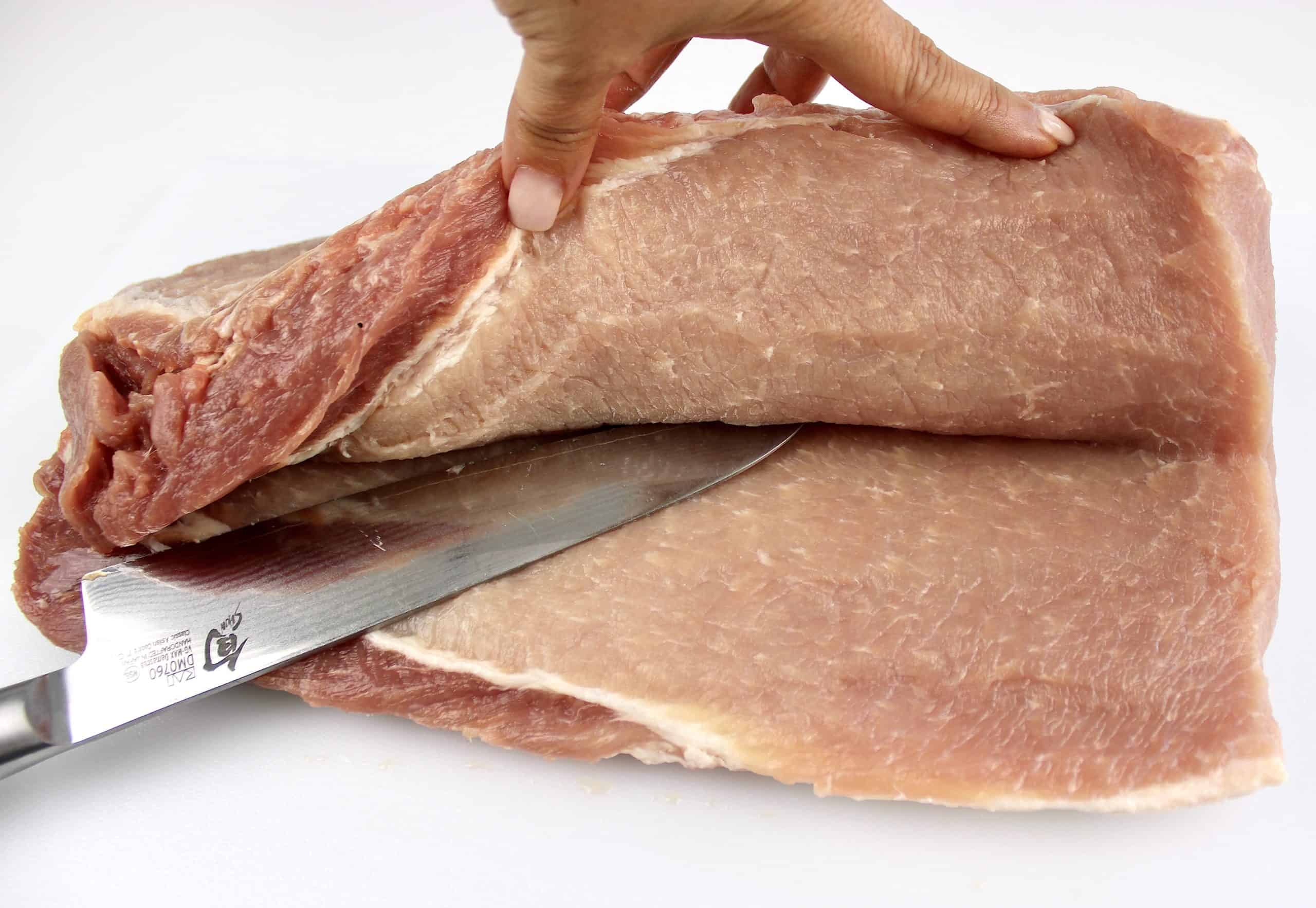 slicing pork loin open with knife