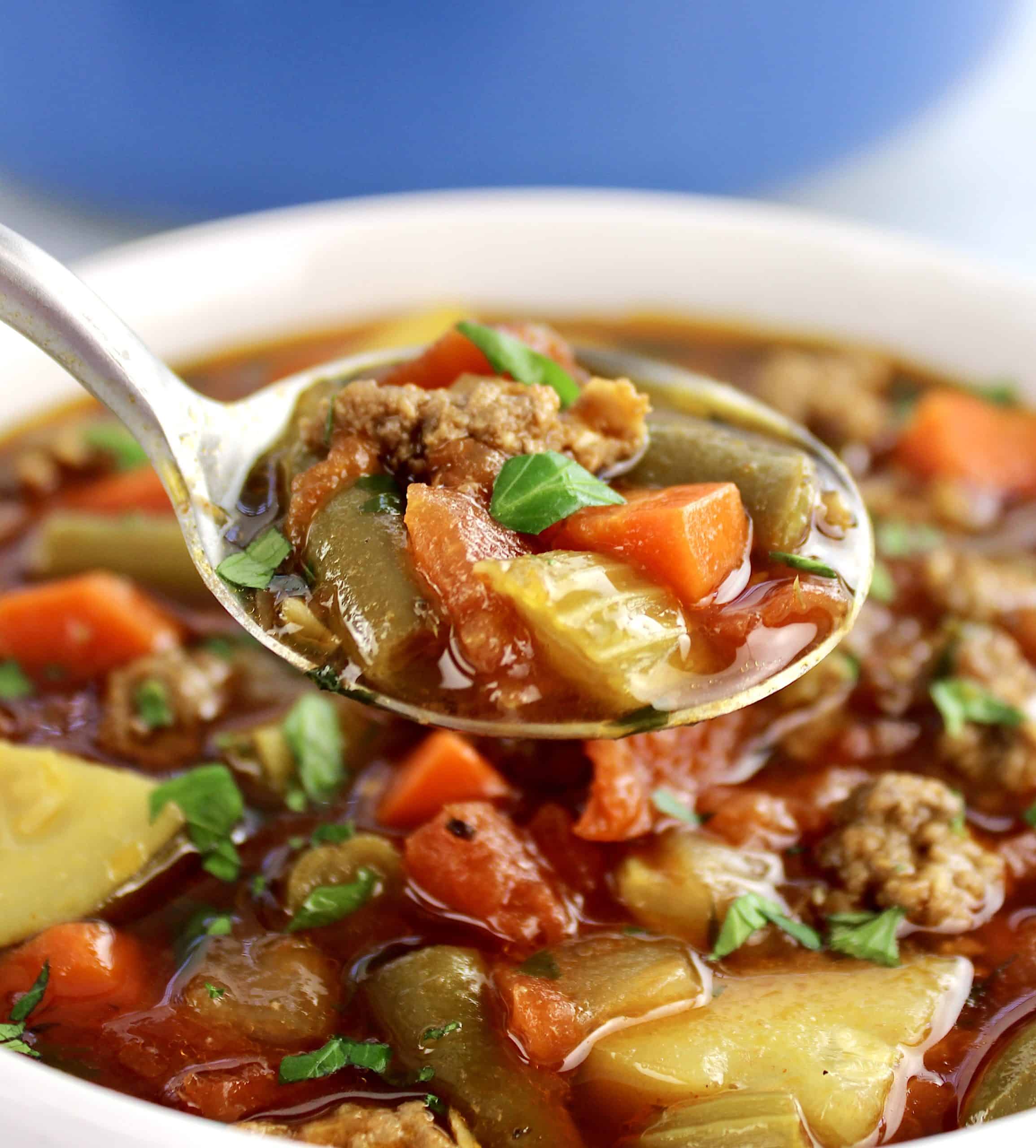 Vegetable Beef Soup being held up with spoon