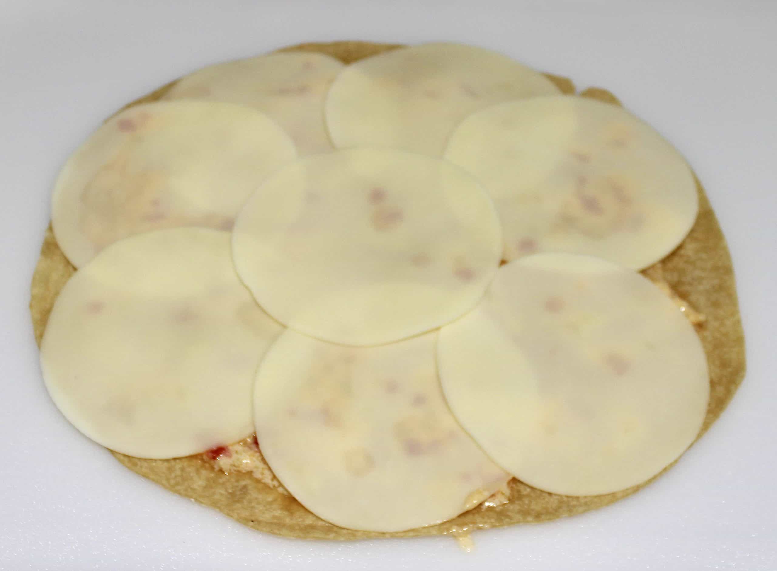 8 slices of provolone cheese on tortilla