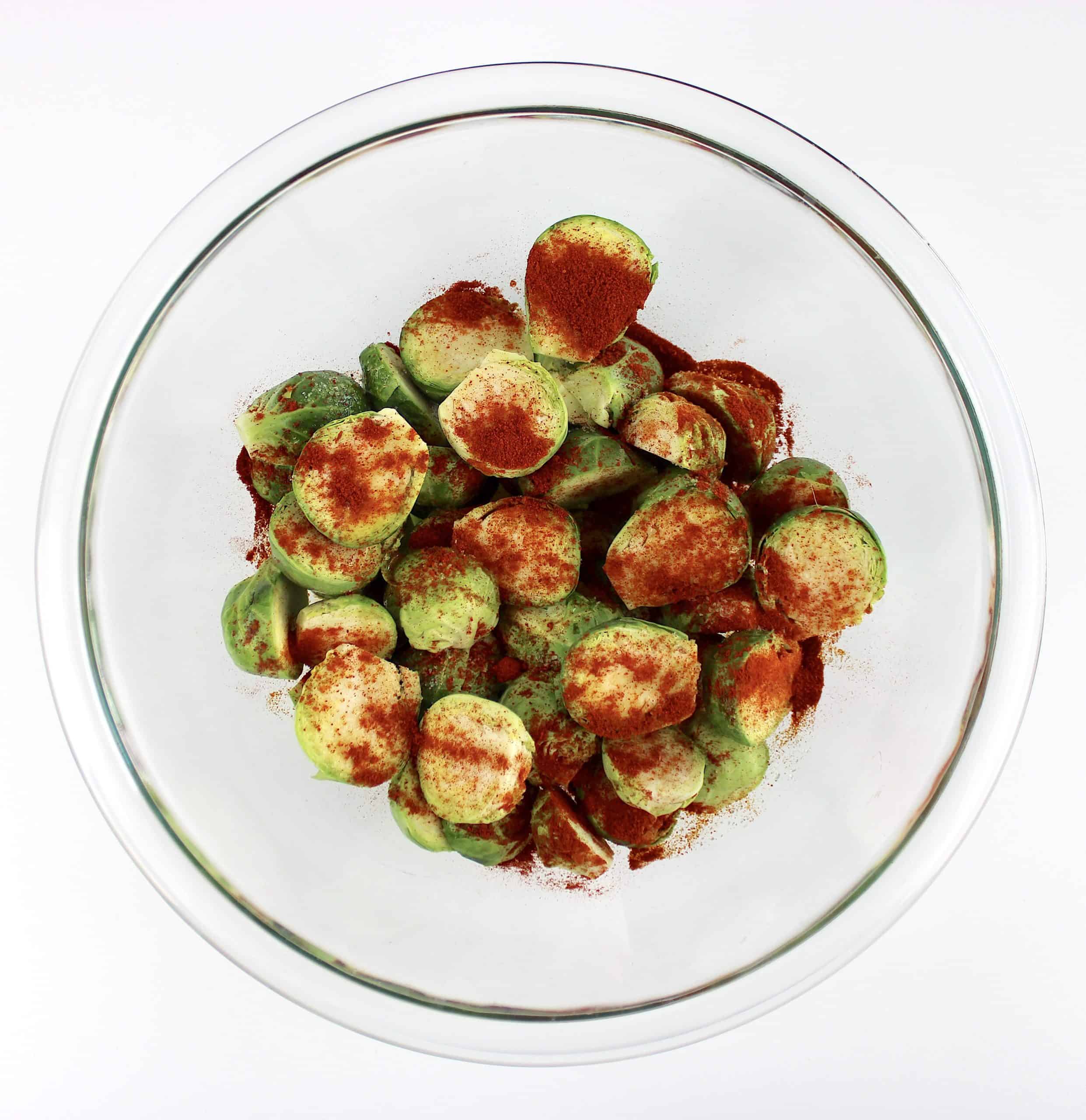 brussels sprouts in glass bowl with spices on top