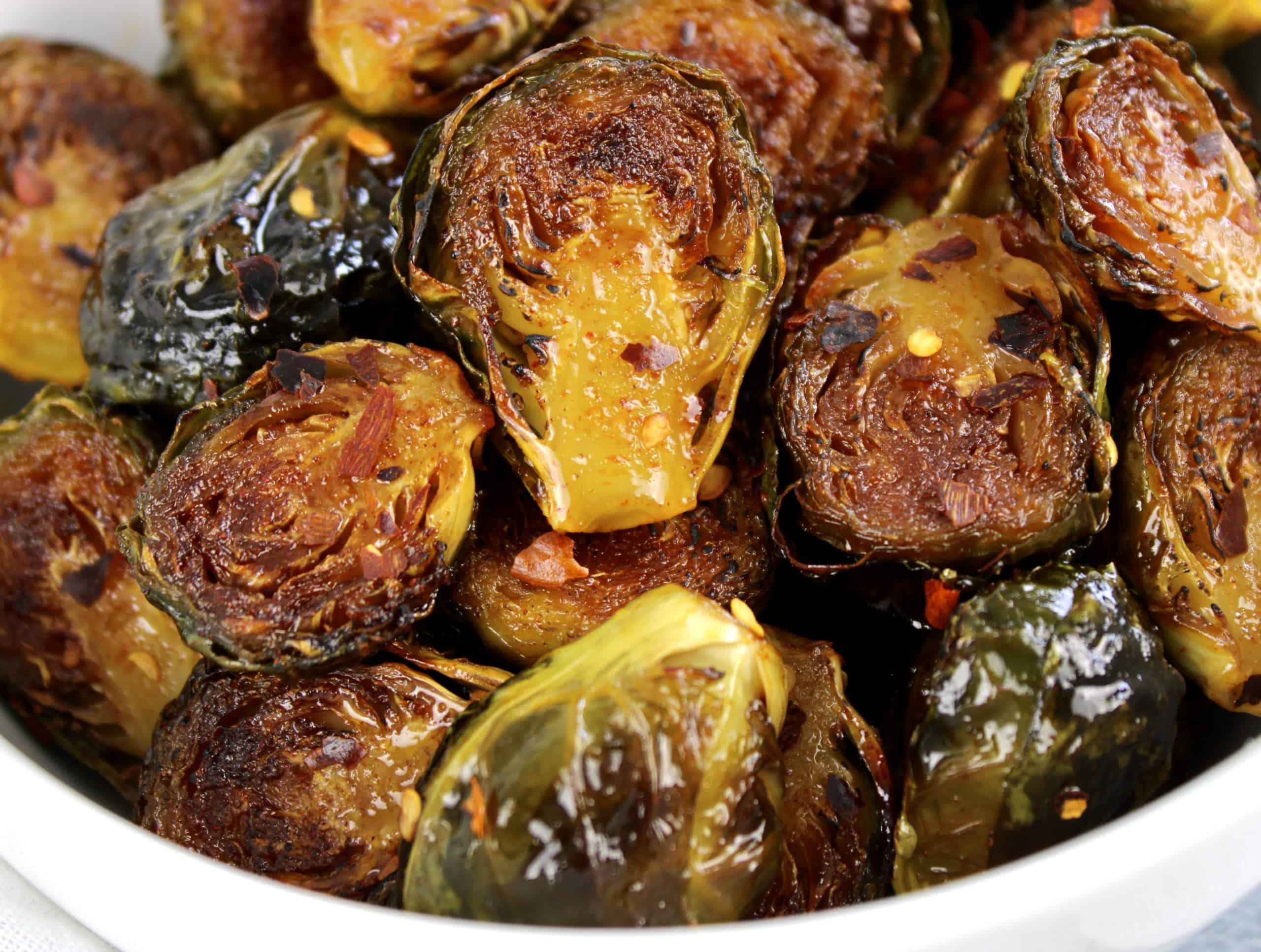 closeup of Honey Roasted Brussels Sprouts in white bowl