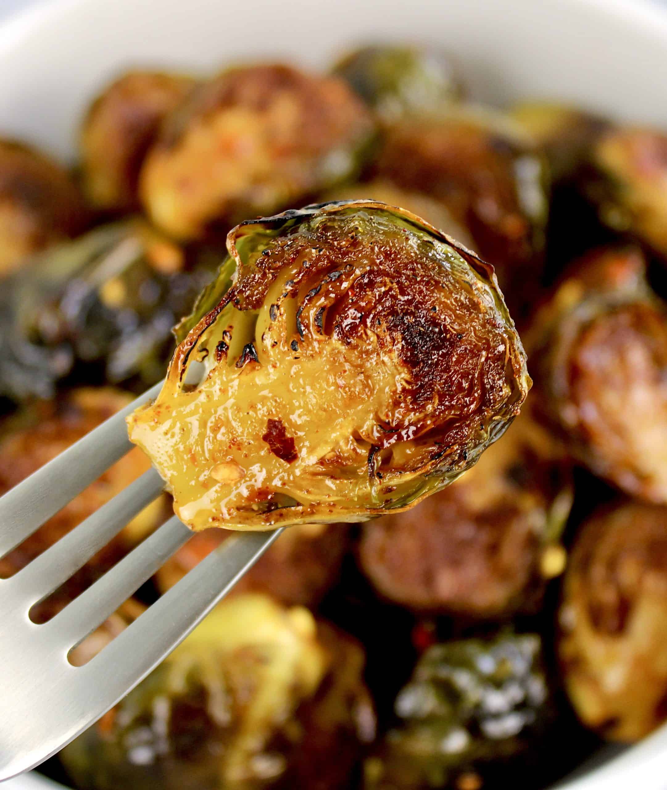 Honey Roasted Brussels Sprouts holding one up on fork