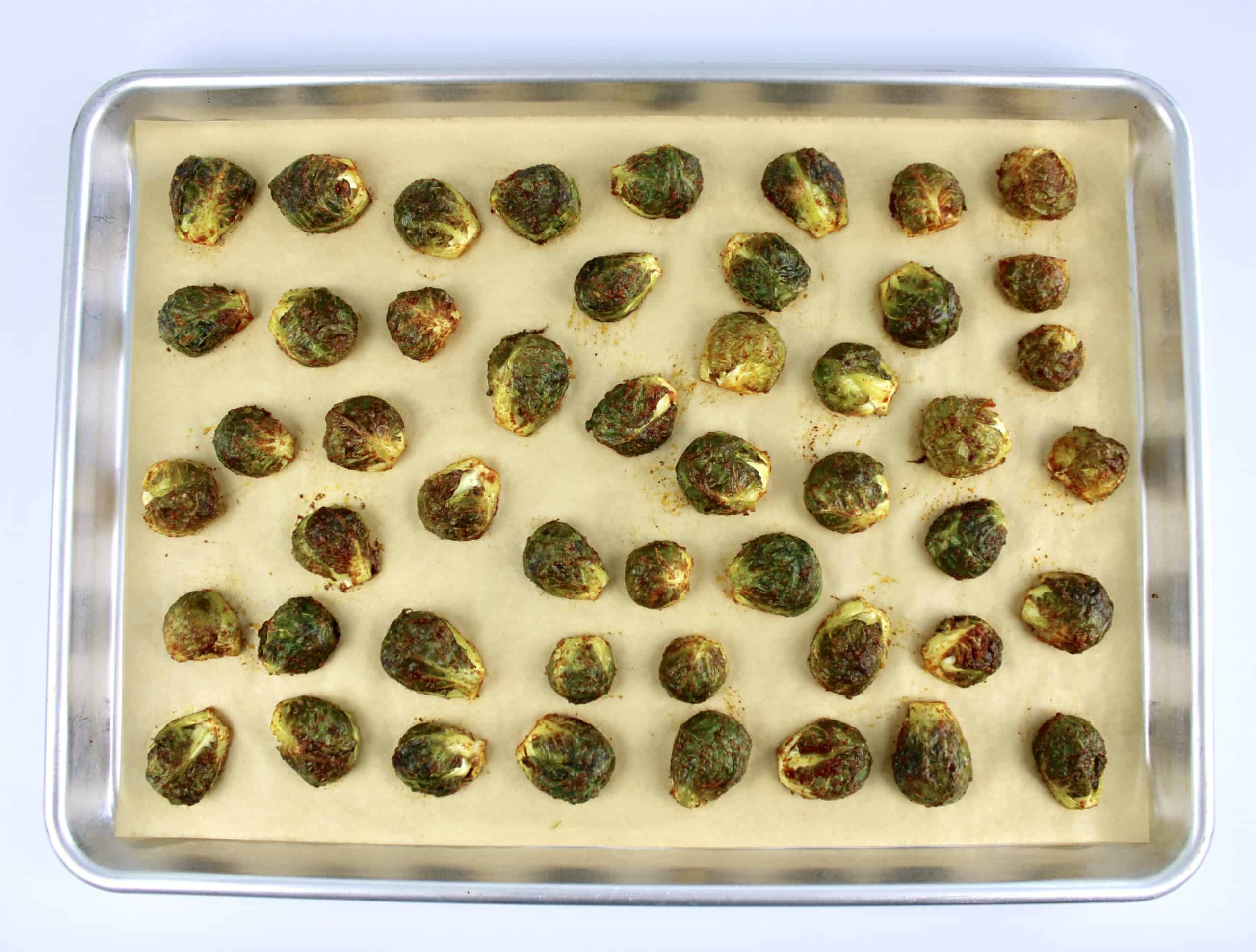 Honey Roasted Brussels Sprouts on parchment lined baking sheet