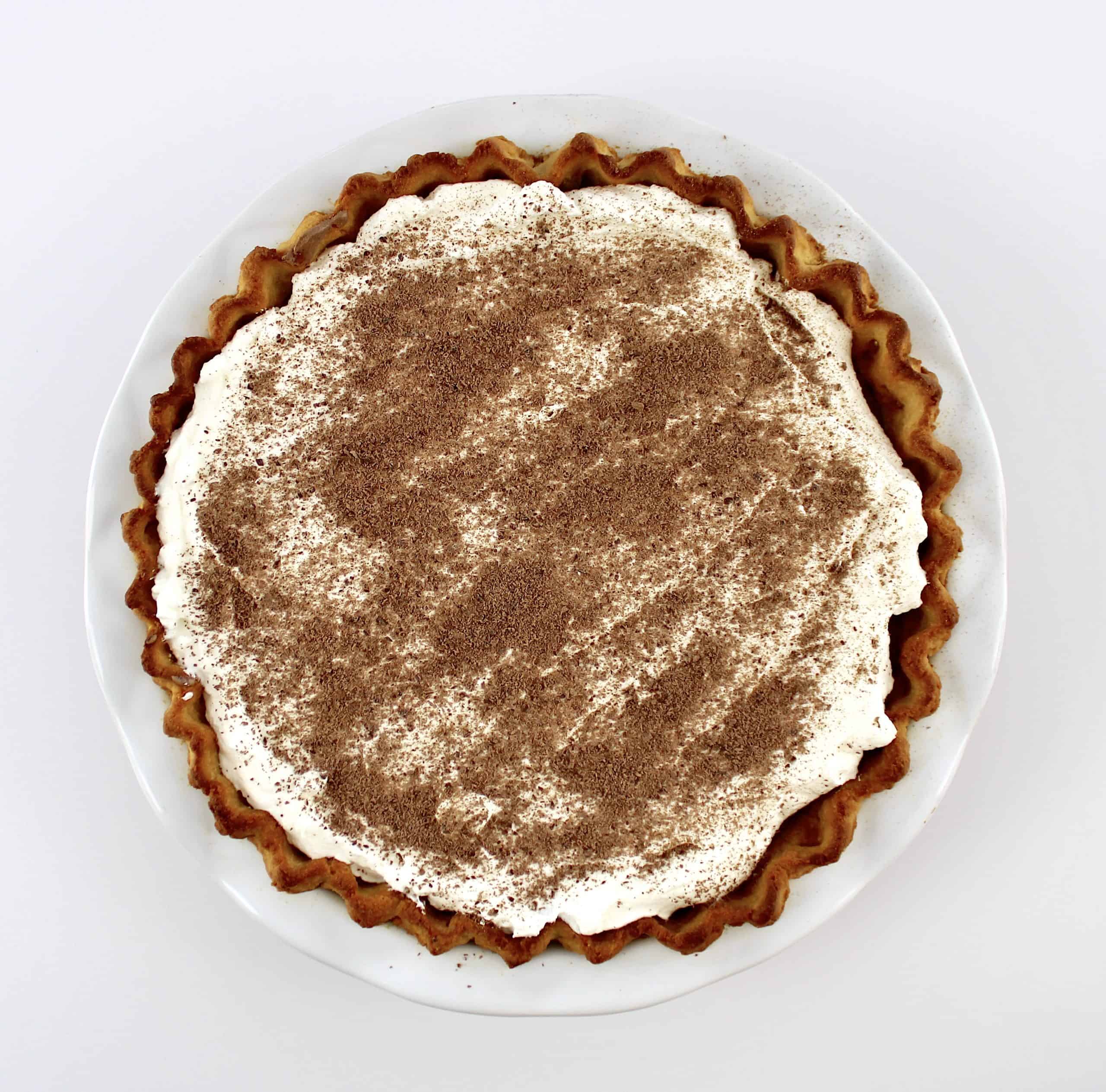 chocolate cream pie with whip cream and shaved chocolate on top