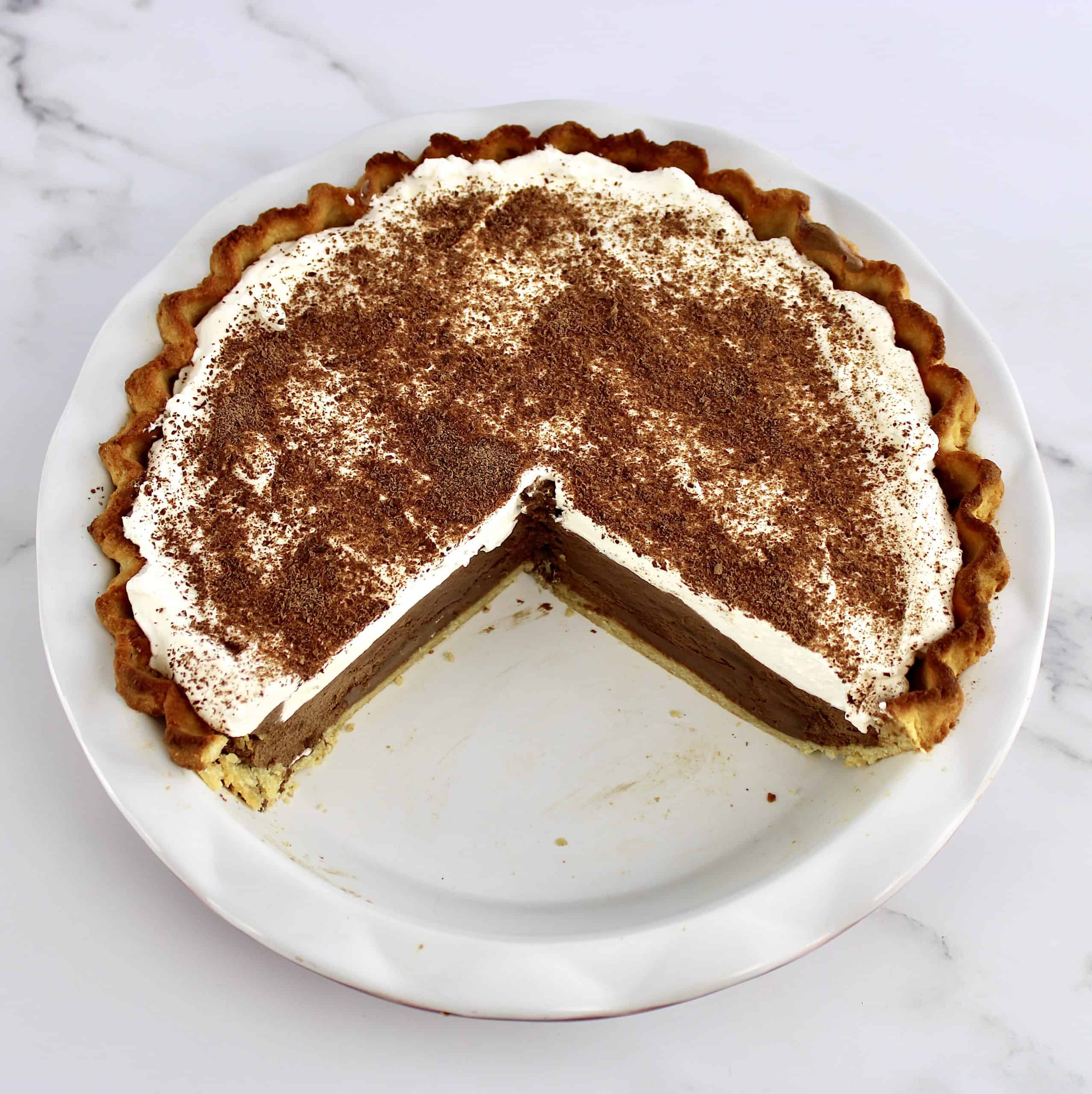 overhead view of chocolate cream pie with slice missing