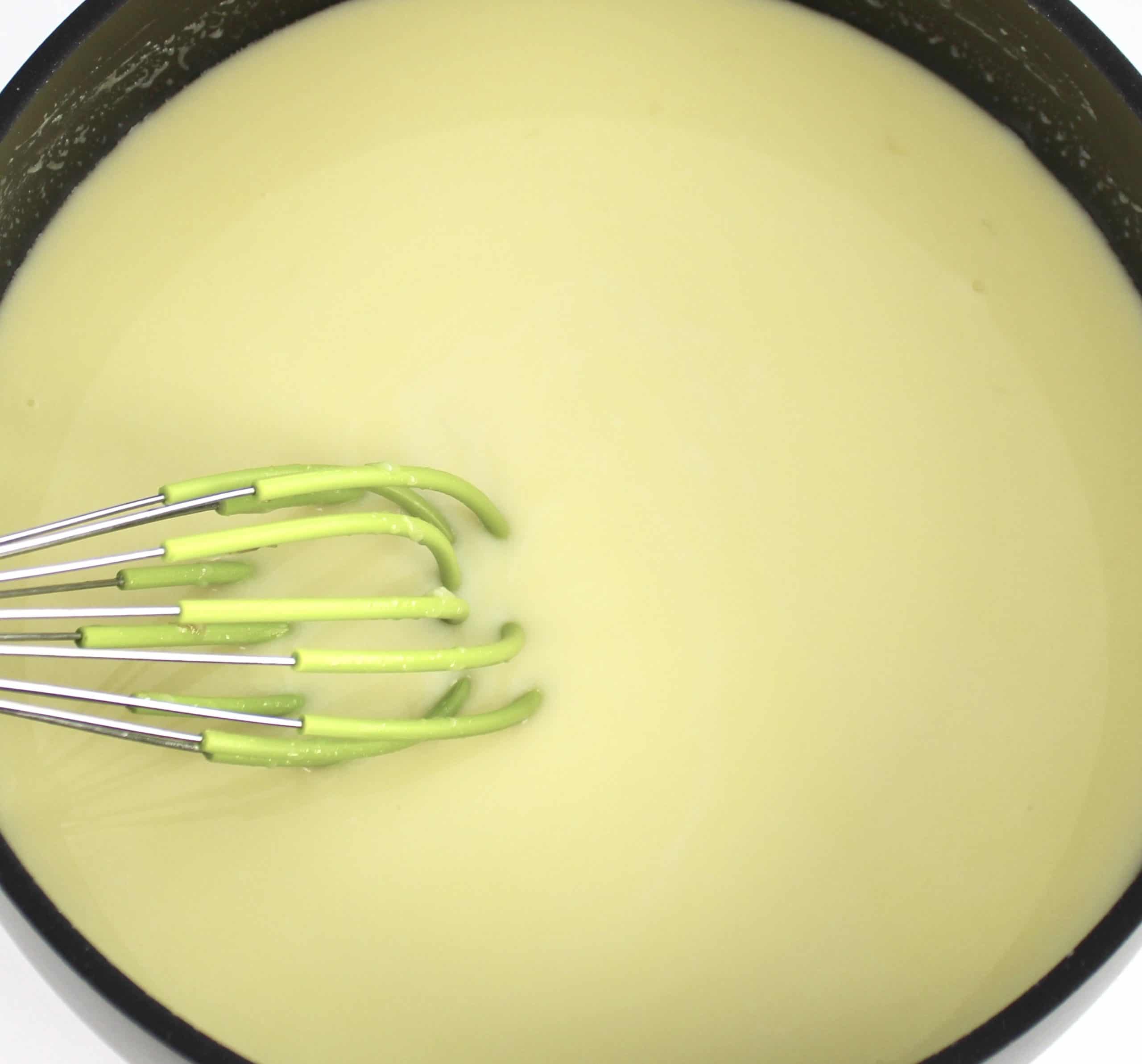 sweetened condensed milk in saucepan with whisk